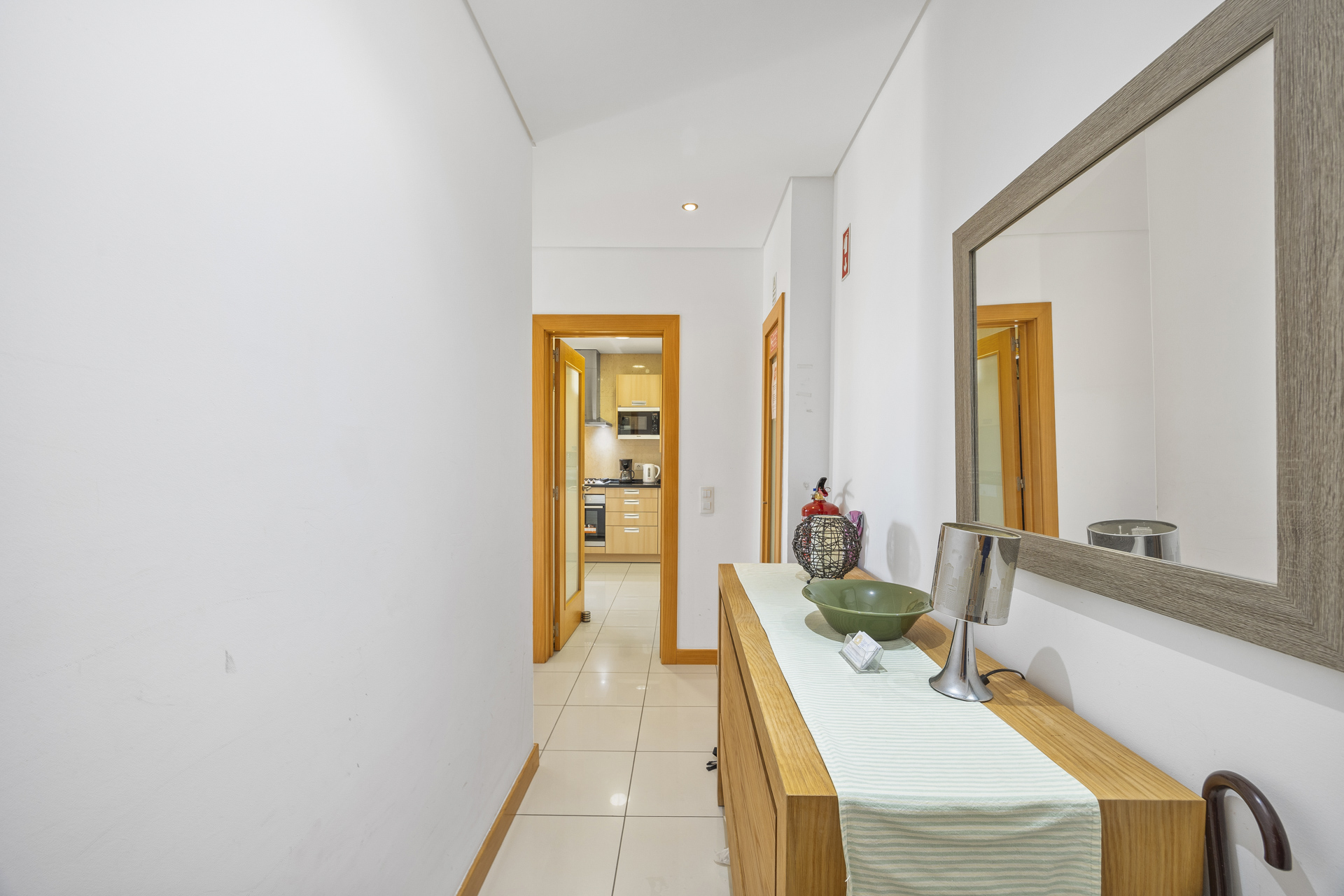 Entrance hallway with console table, mirror, and view through to the kitchen