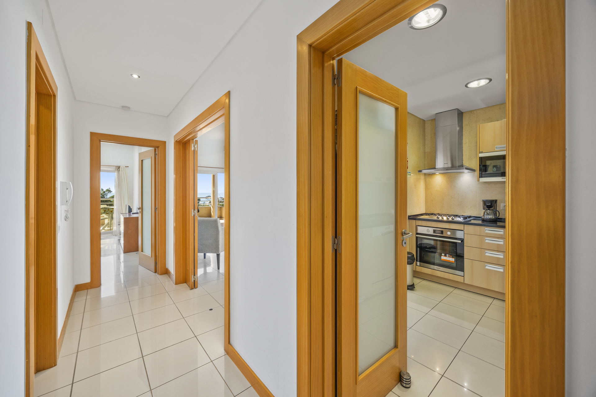 Hallway with frosted glass door opening to the kitchen