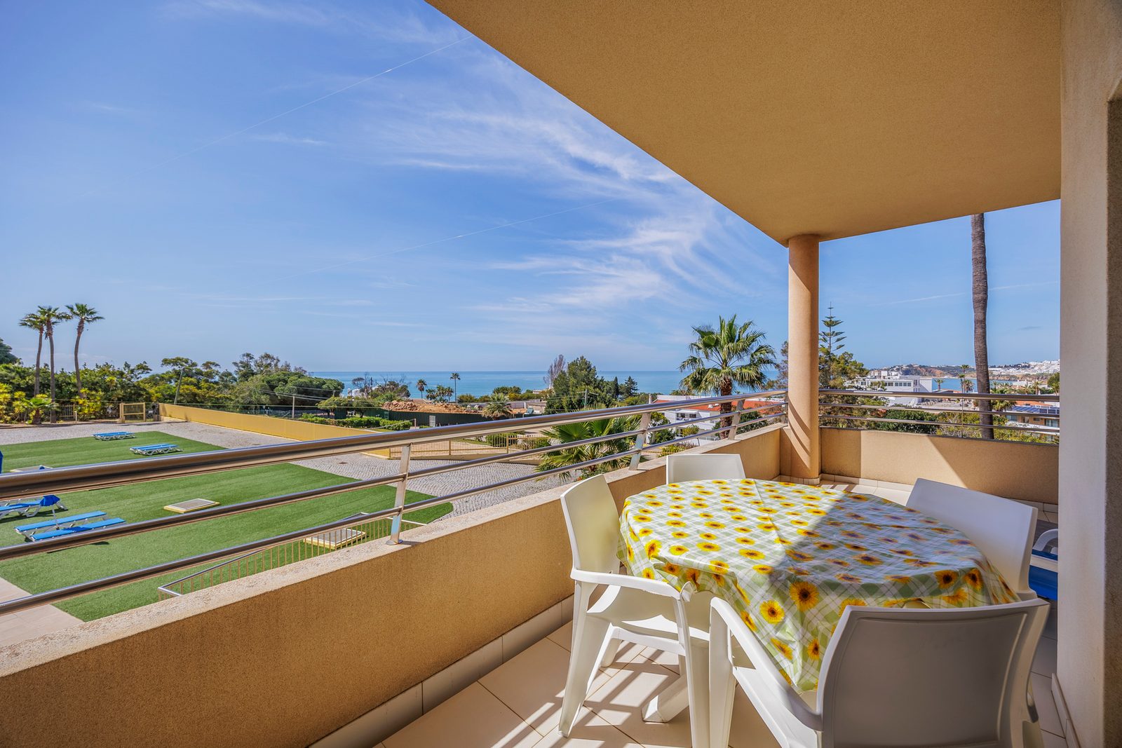 Balcony with dining table, chairs, and sea view