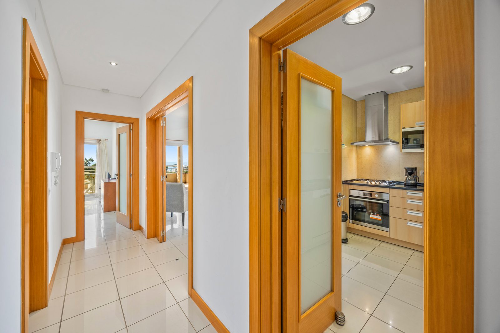 Hallway with frosted glass door opening to the kitchen