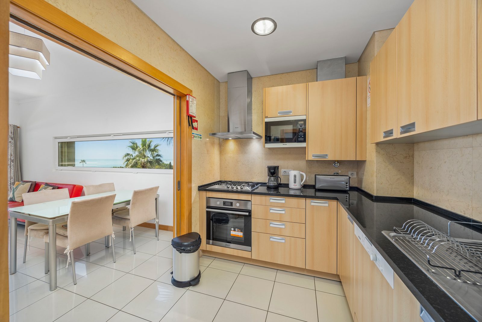 Kitchen with view through to the dining area and sea beyond