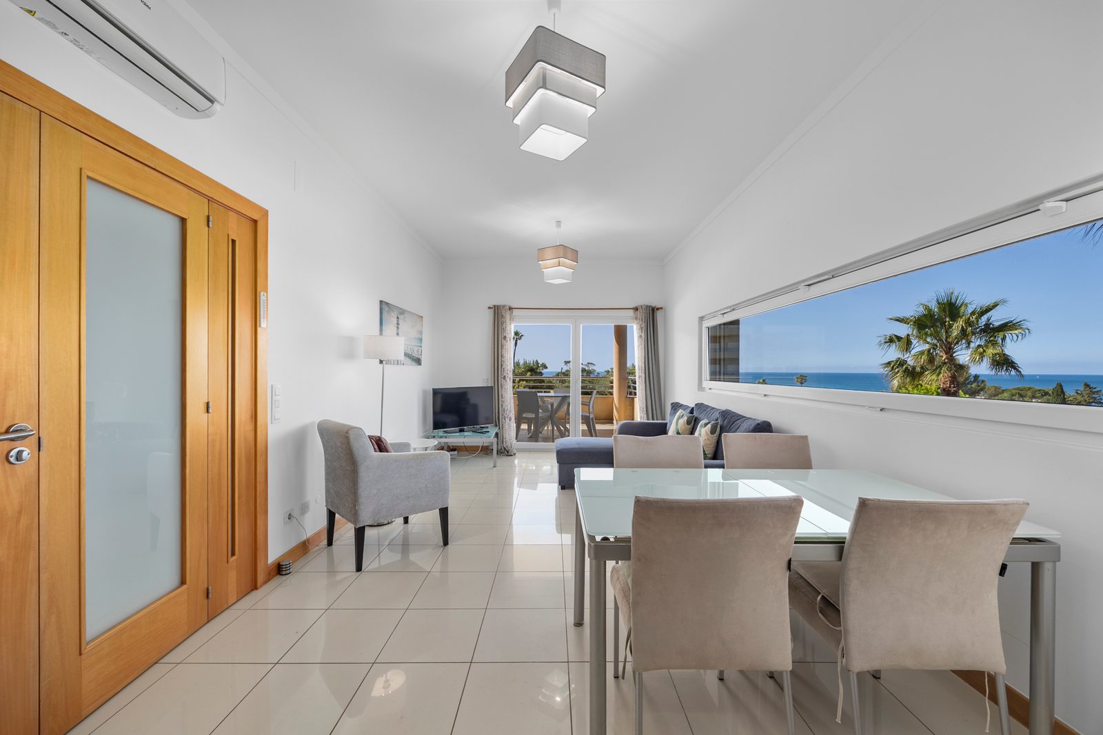 Living and dining area with dining table and sea-view window