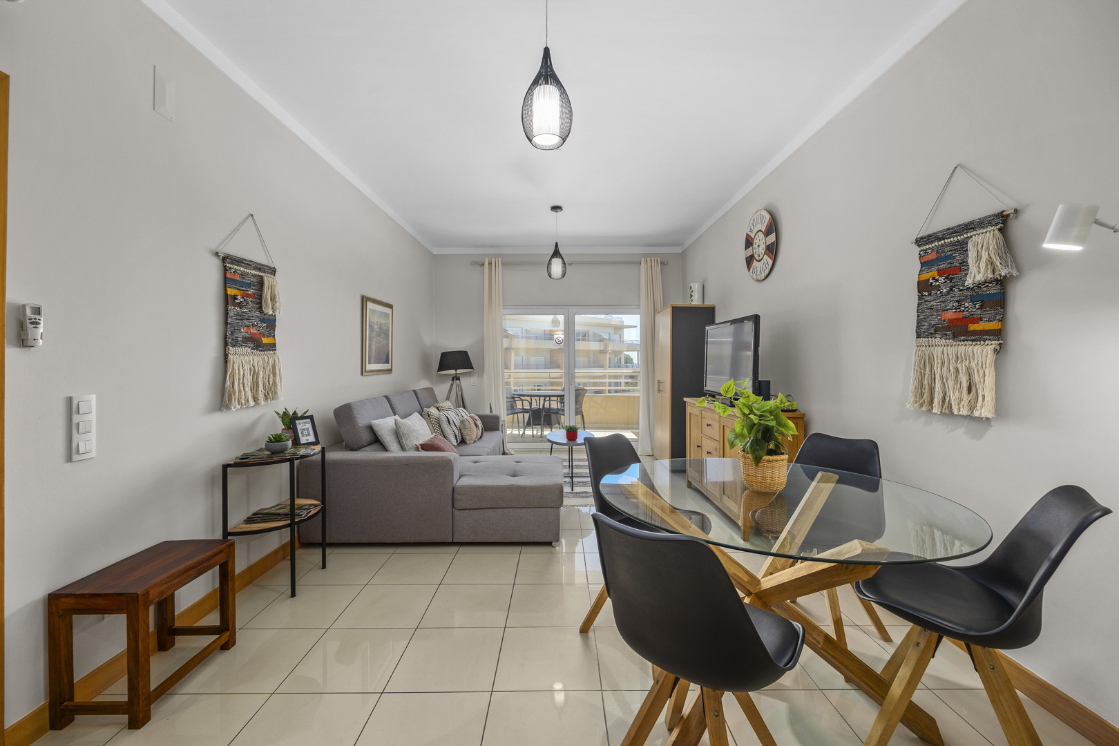 Dining area with woven wall hangings and glass dining table