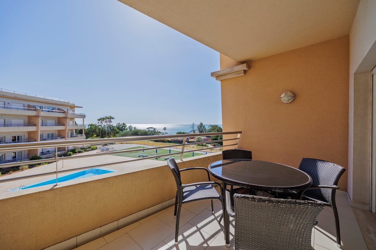Balcony dining table with pool and sea view