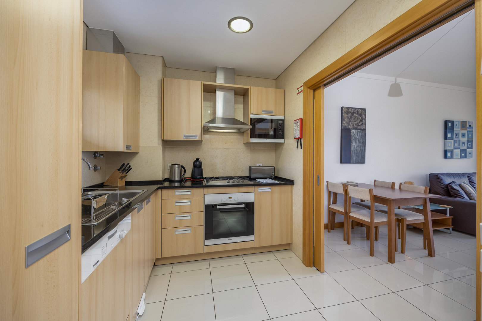 Kitchen with wooden cabinetry and view through to the dining area