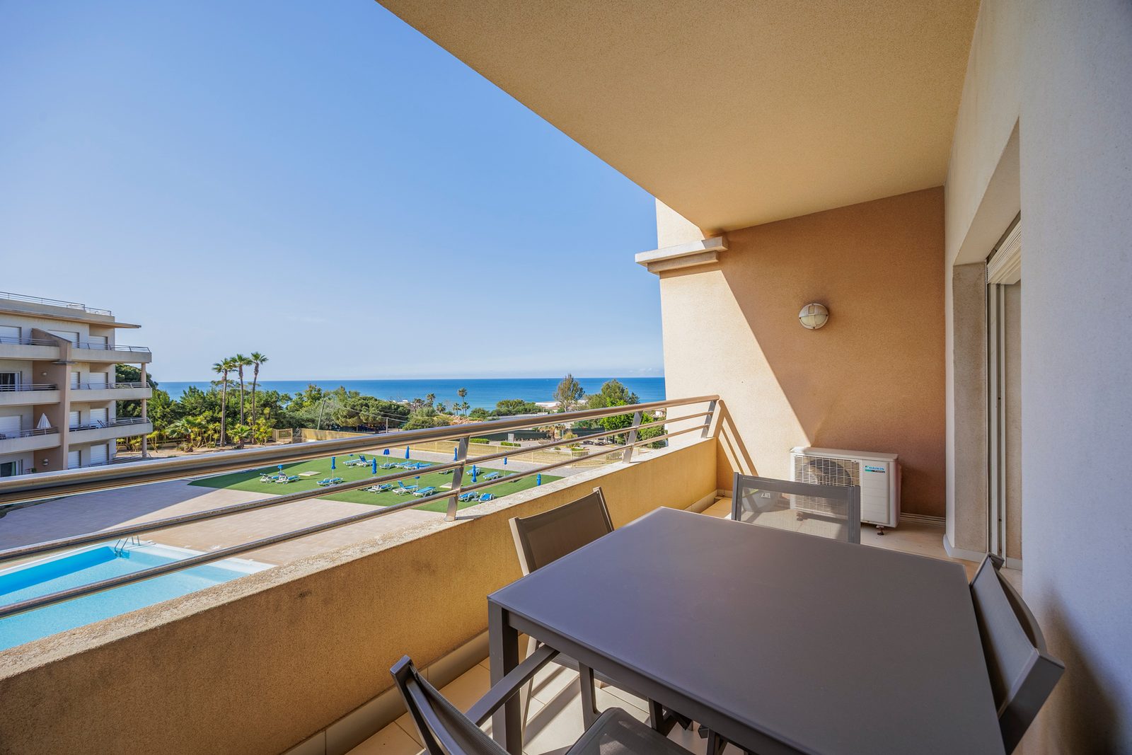 Balcony with dining table and coastal view