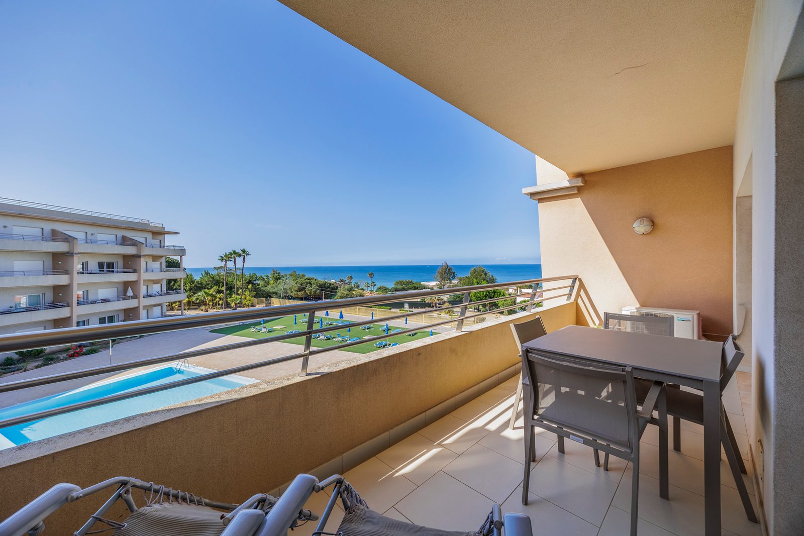 Balcony with dining table and sea view