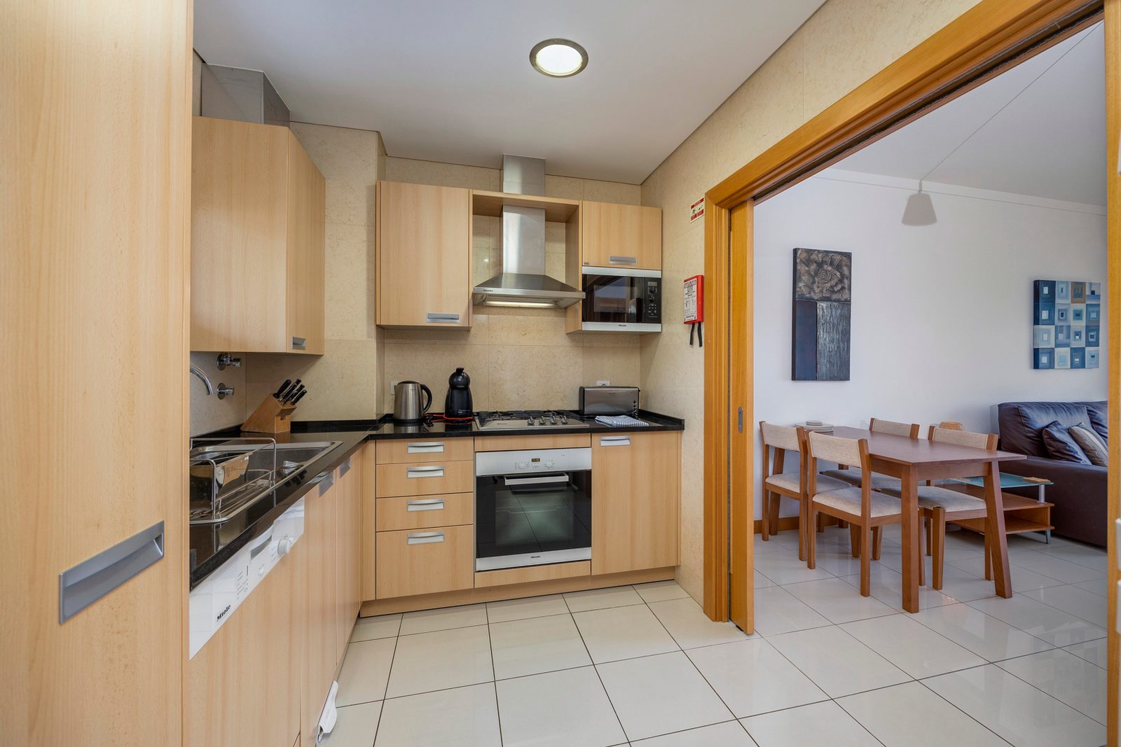 Kitchen with wooden cabinetry and view through to the dining area