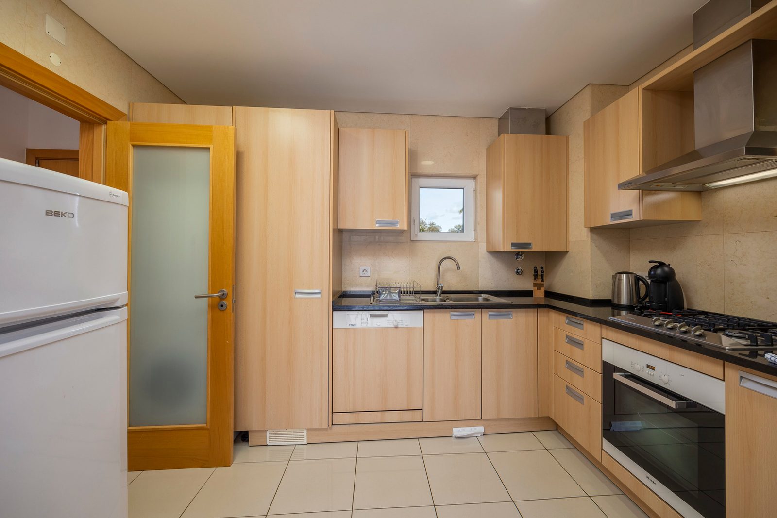 Kitchen with fridge, dishwasher, and gas hob