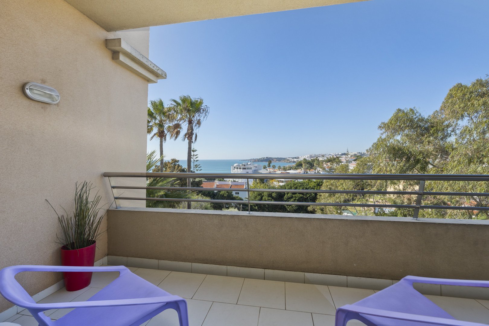 Balcony with lounge chairs and coastal view