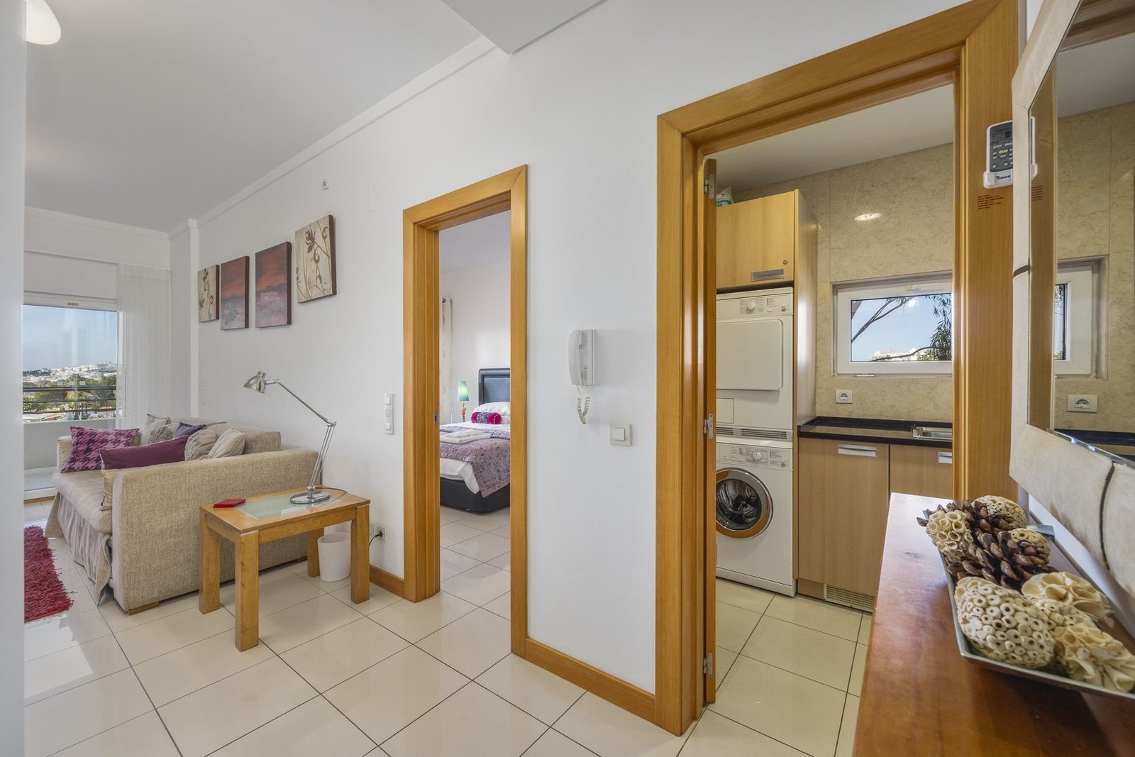 Hallway with mirror and doors through to the living room and kitchen