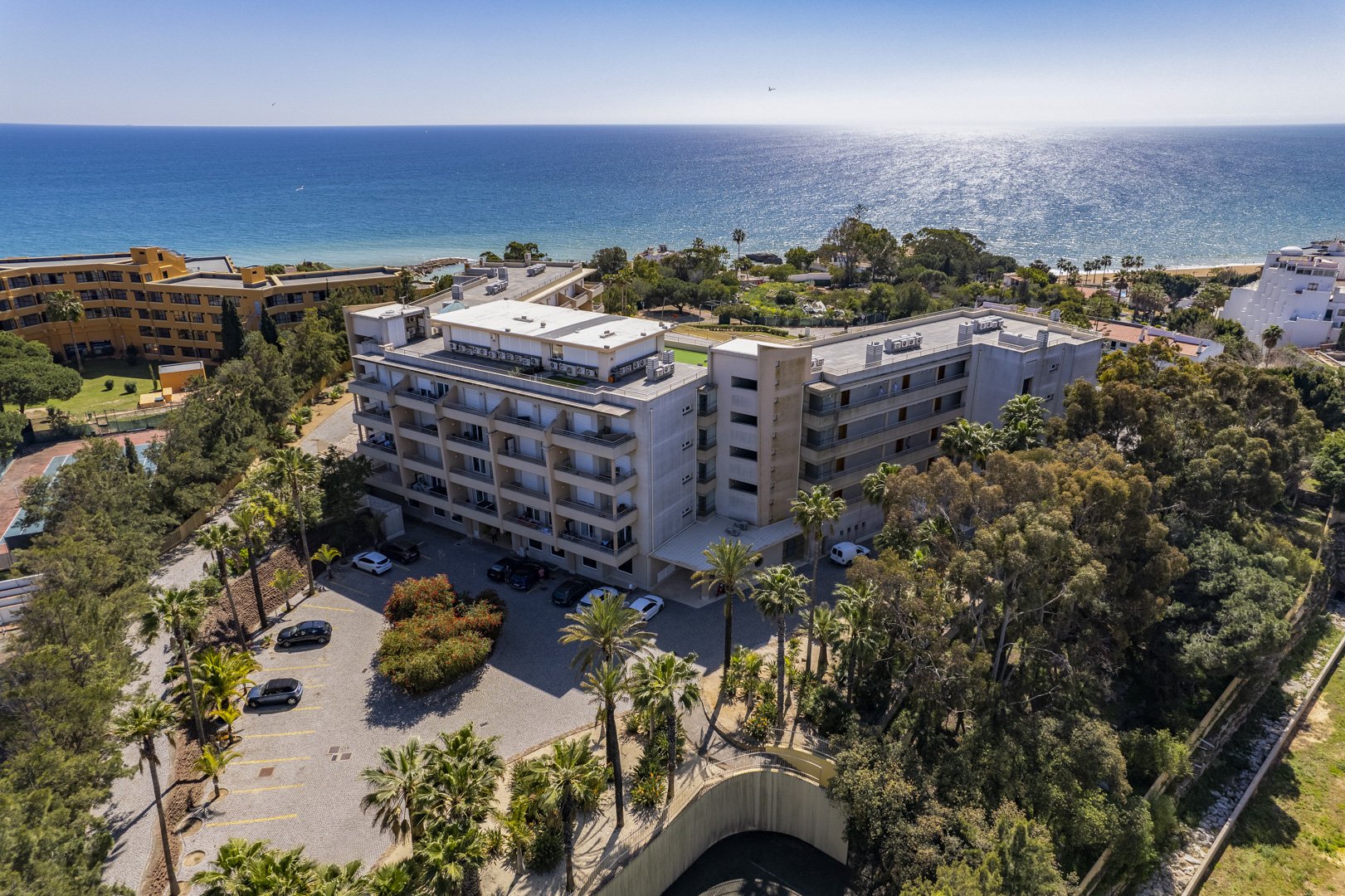 Aerial view of the building, parking area, and coastline