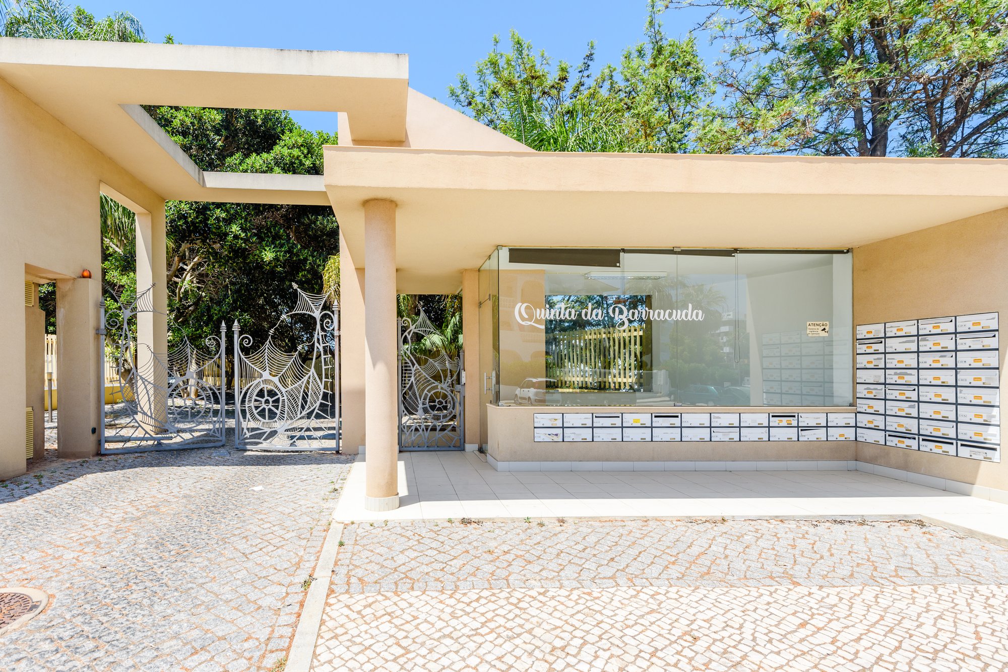 Complex entrance gate and mailboxes with Quinta da Barracuda signage