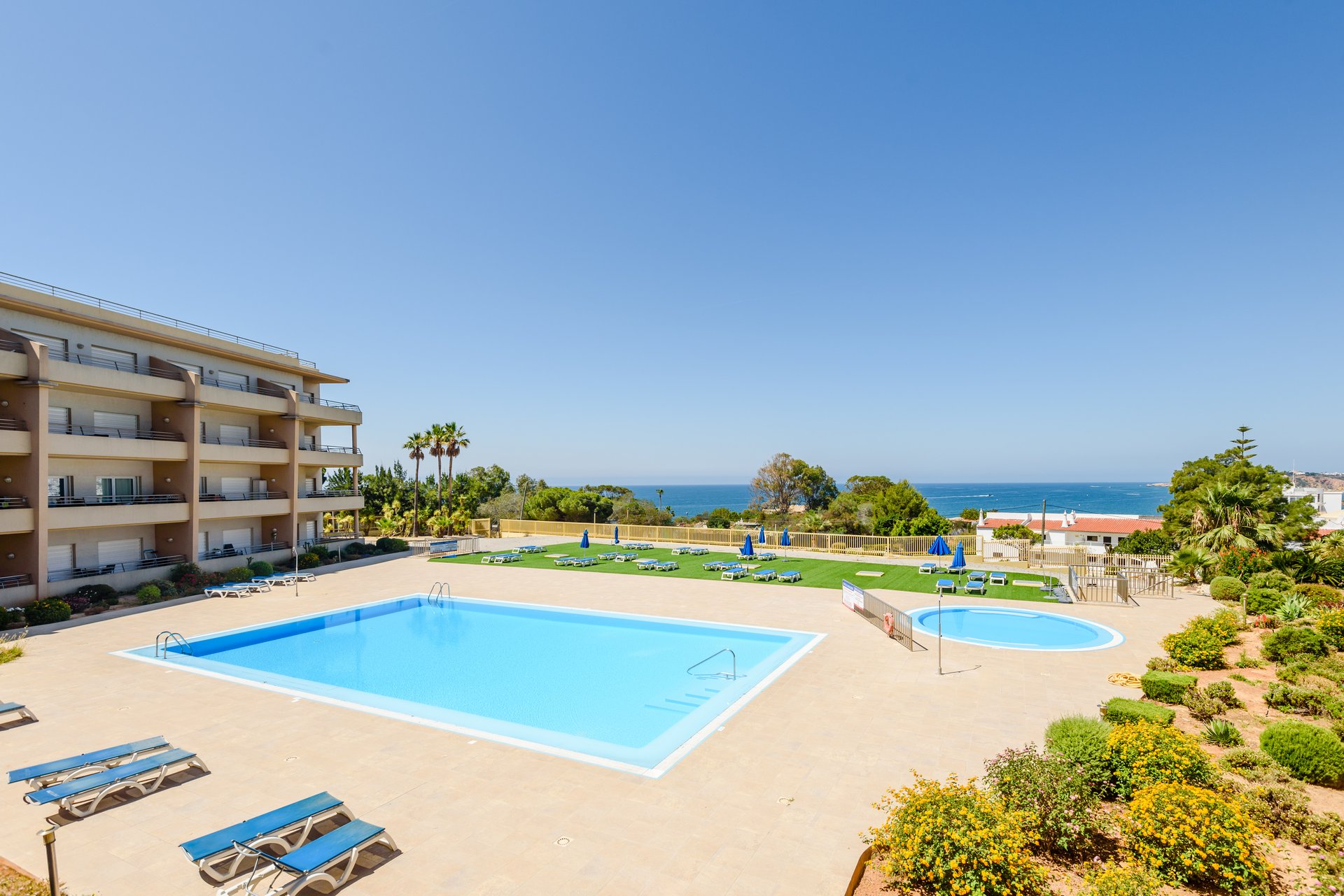 Corner view of the communal pool with the sea beyond
