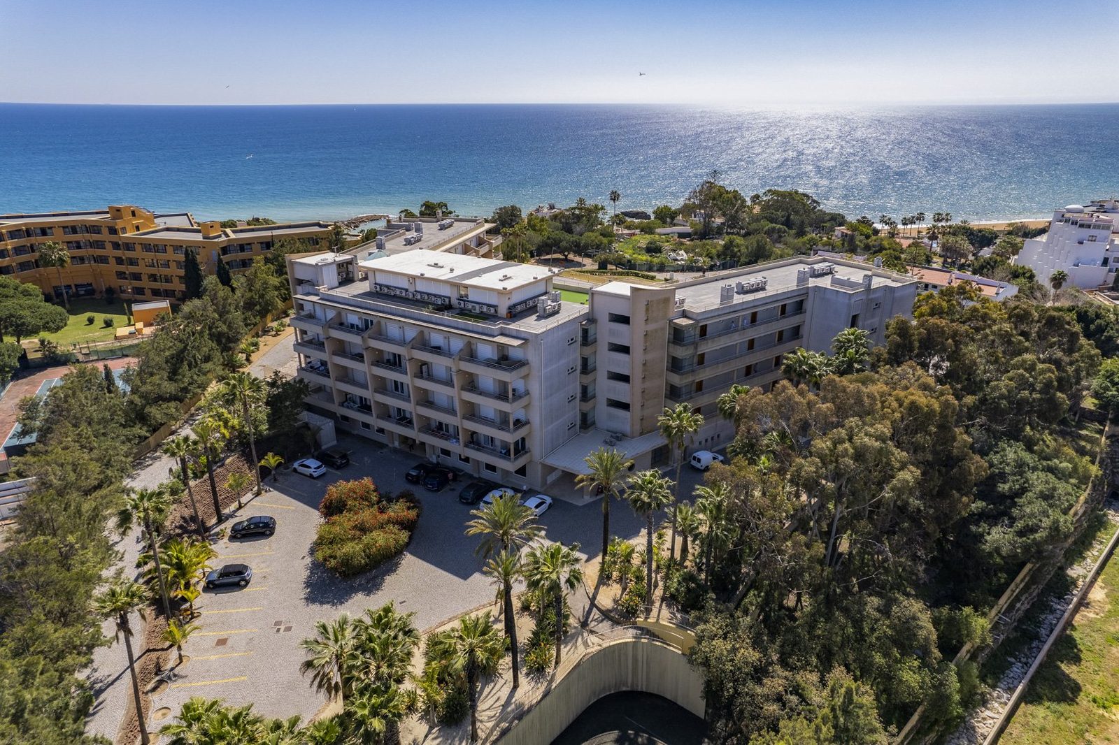 Aerial view of the building, parking area, and coastline
