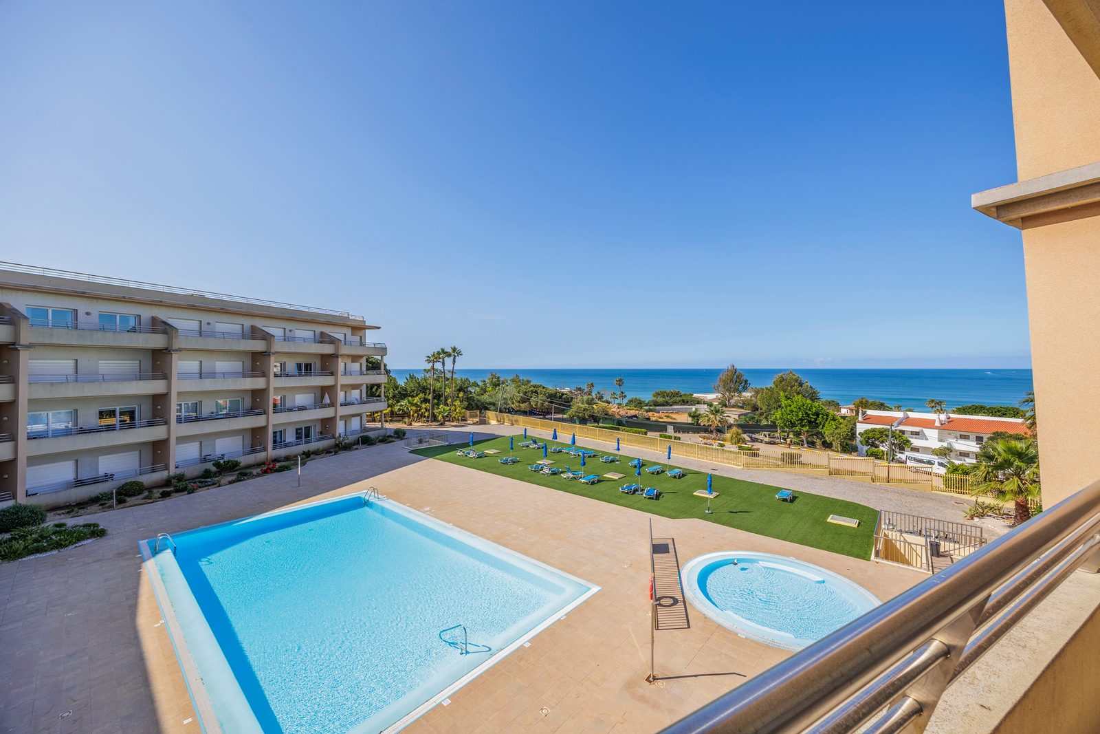 Elevated view of the pool, sun deck, and mini-golf lawn