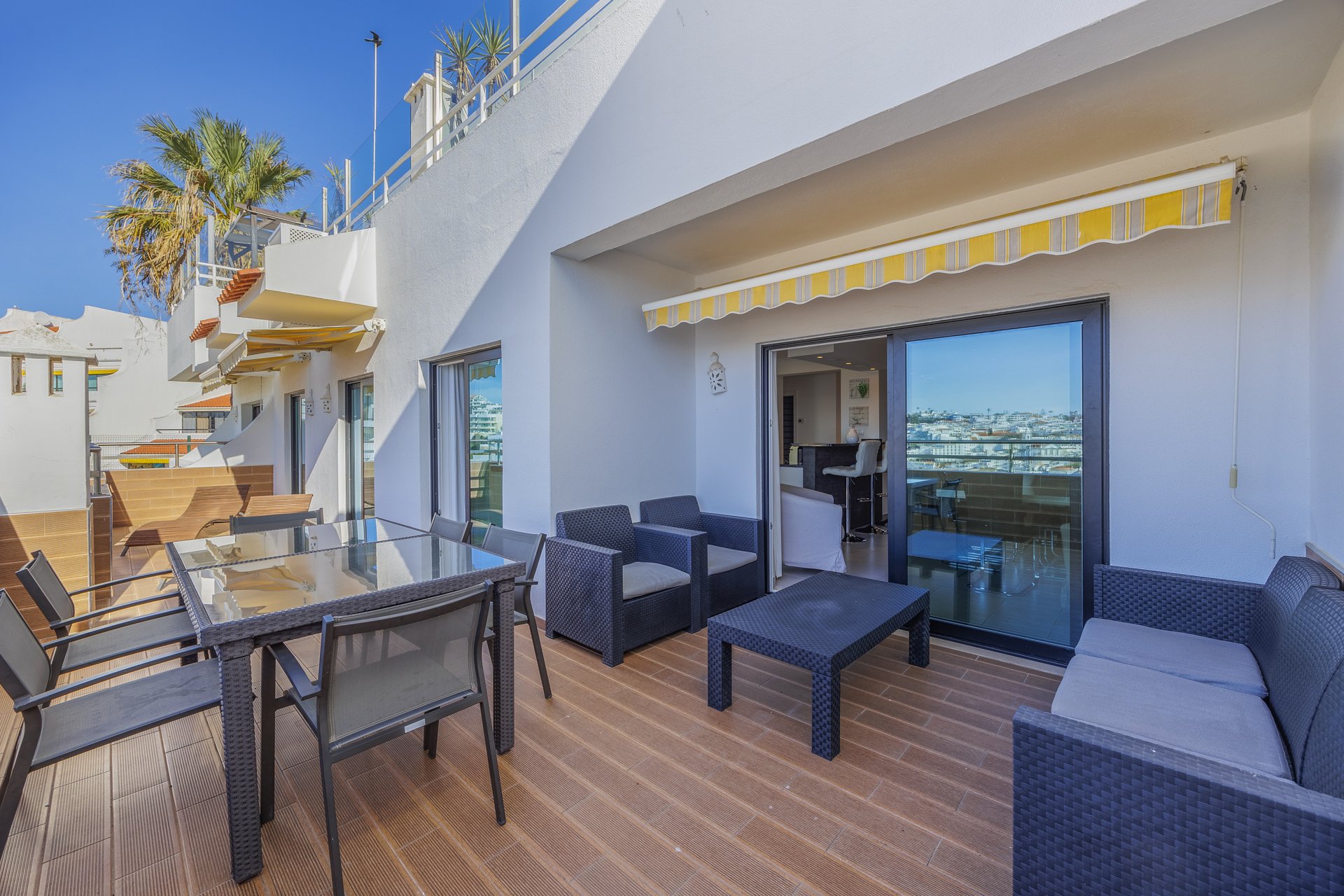 Balcony dining table with sea glimpse and building views