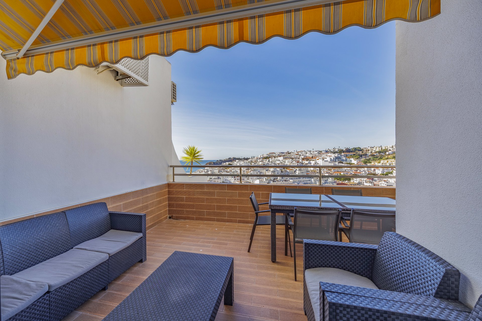Balcony with dining table, sofa, and rooftop view