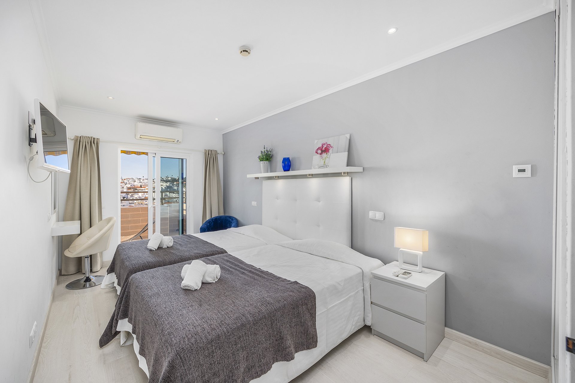 Bedroom with balcony access and town view, alternate view
