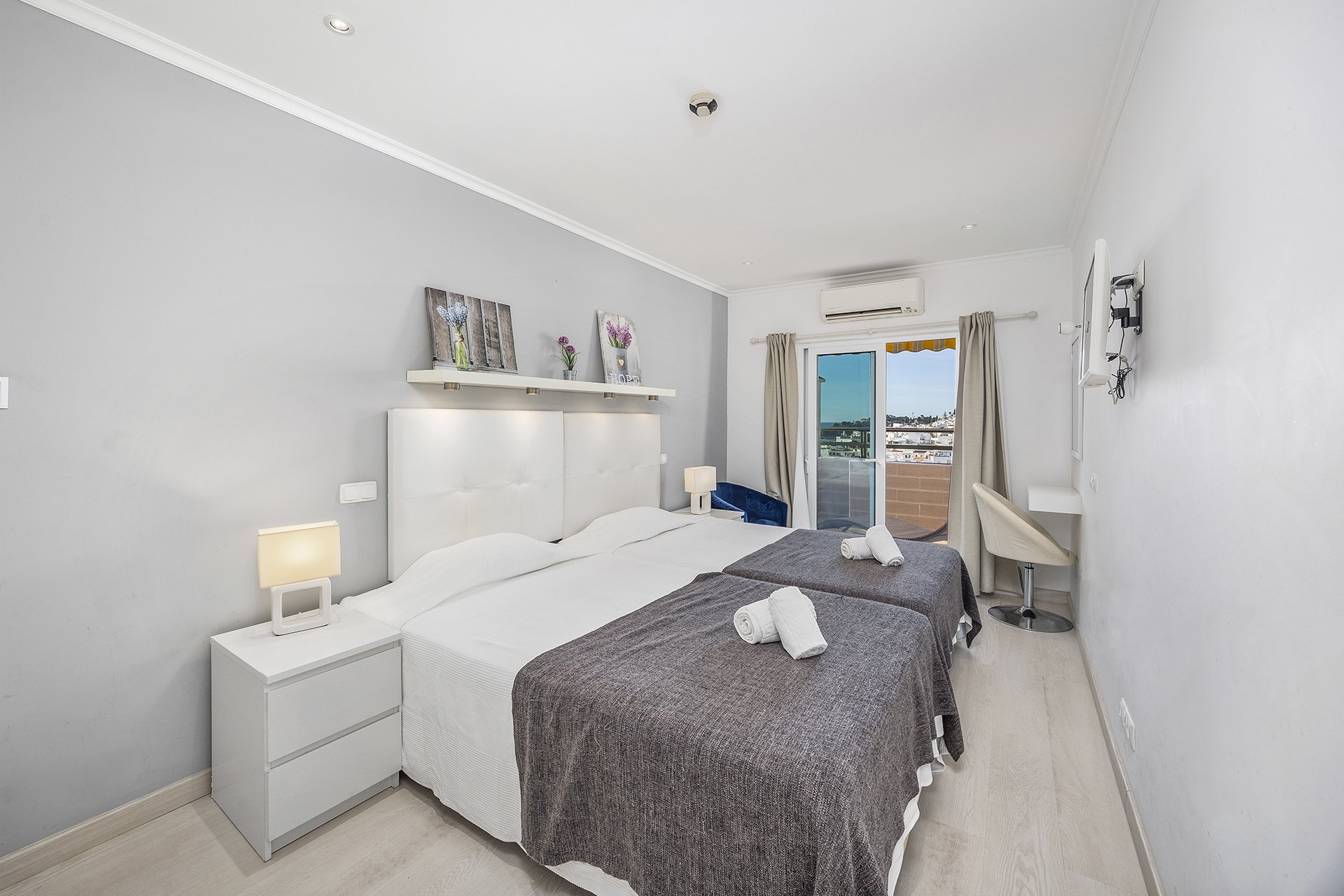 Bedroom with balcony access and town view