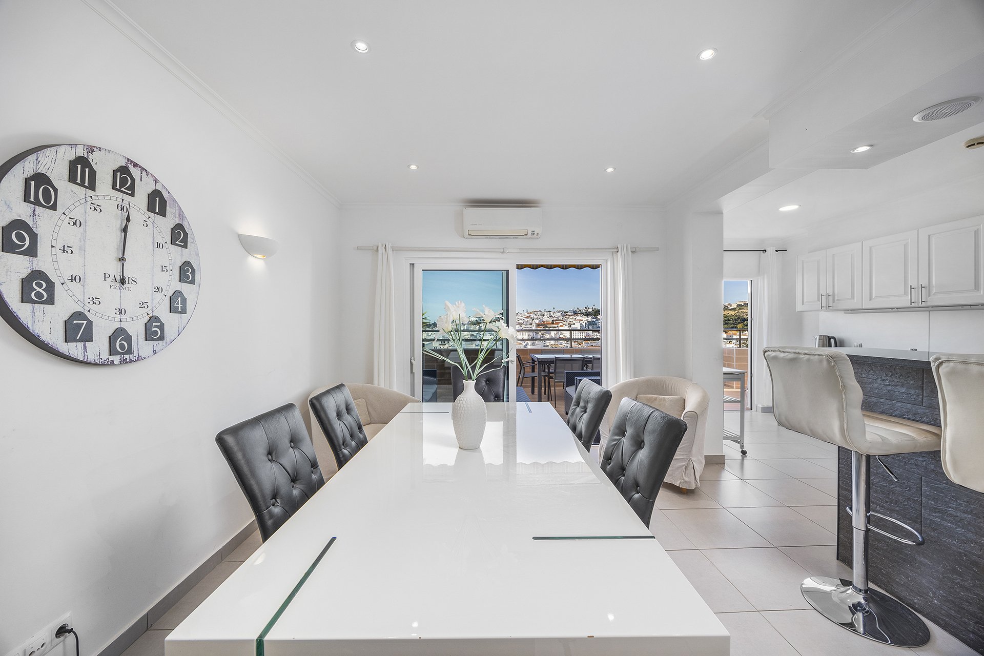 Dining area with views to two balconies and kitchen bar