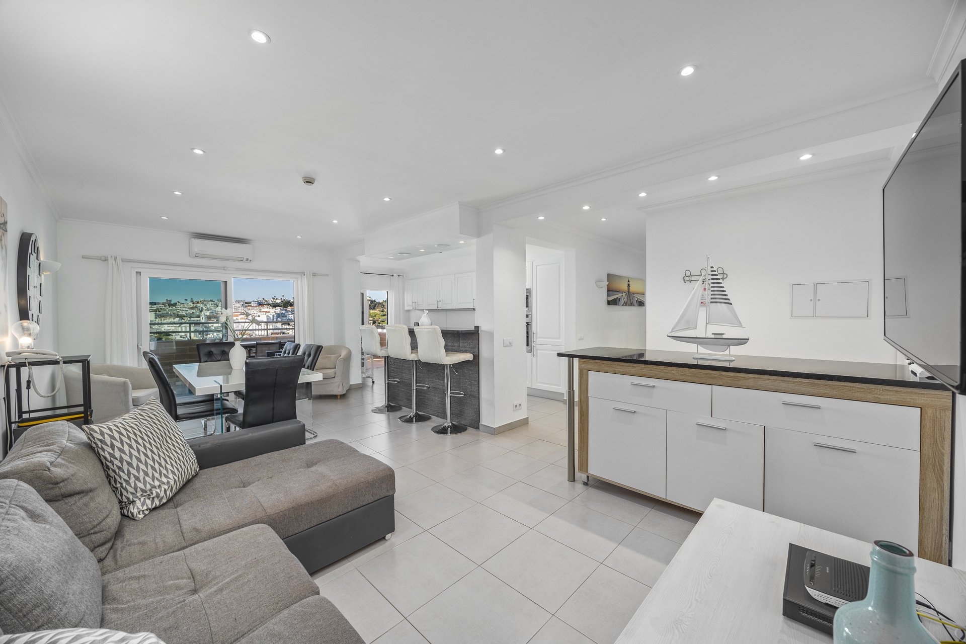 Open-plan living area with dining table and kitchen, alternate view