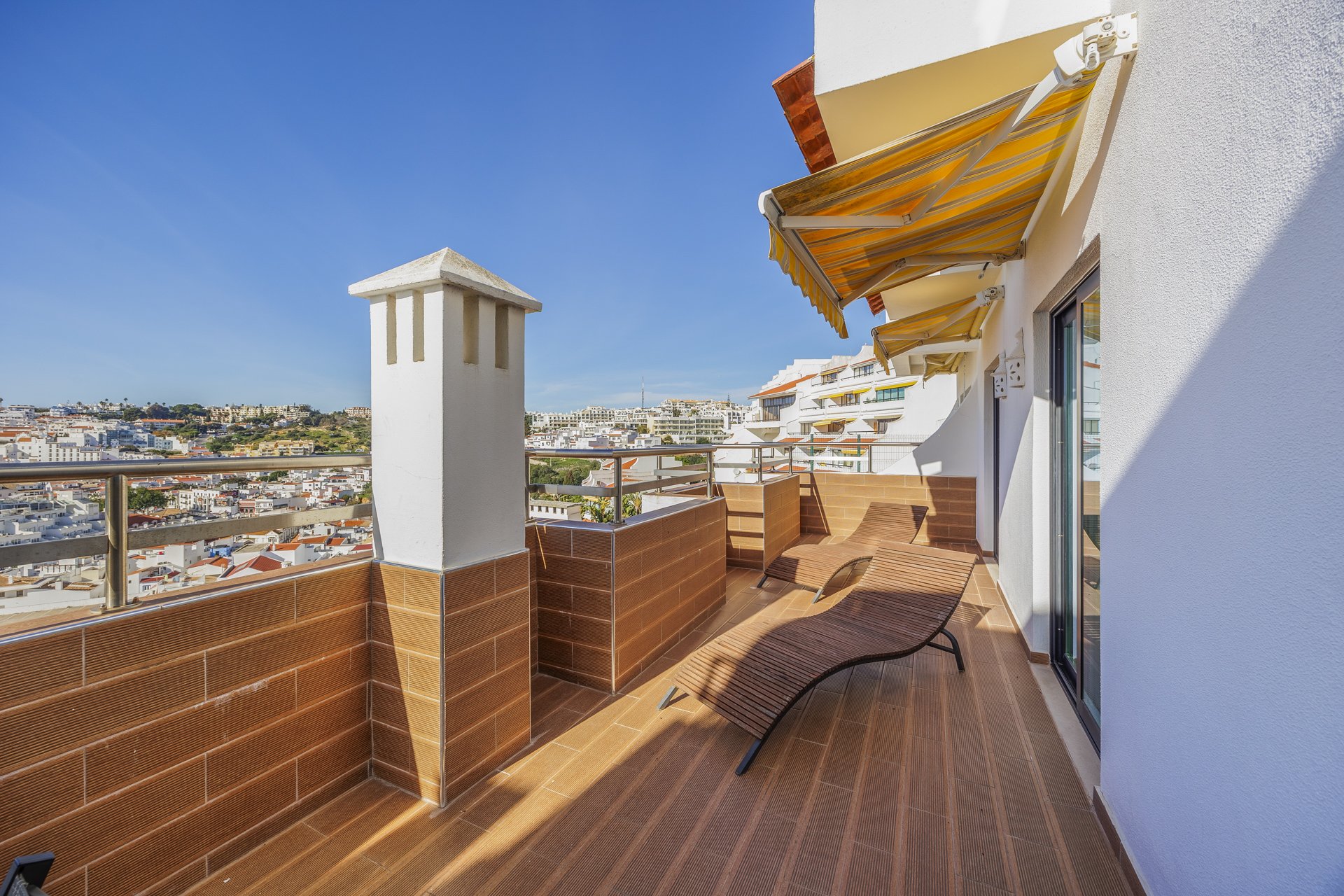 Rooftop terrace with sun loungers and city view