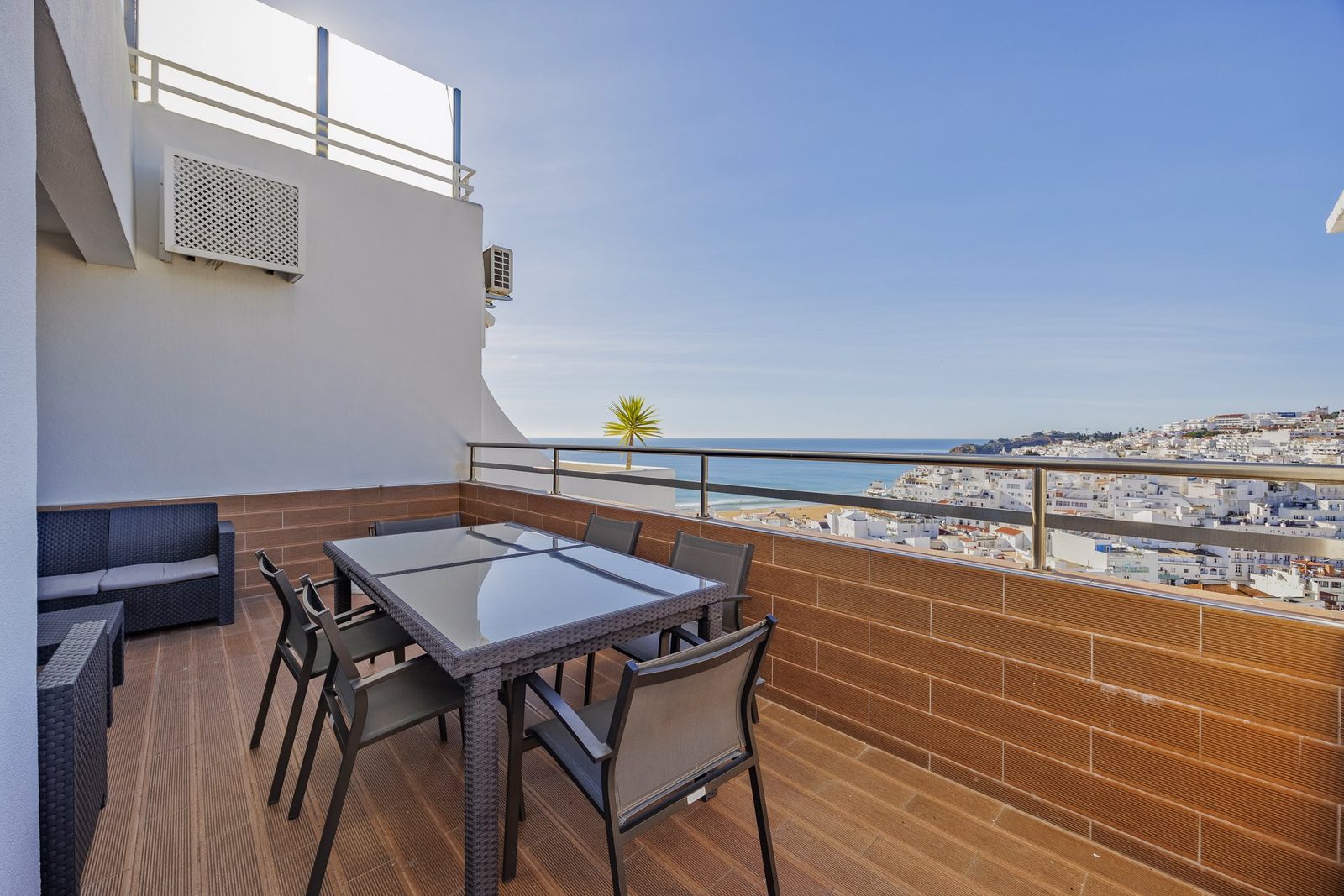 Balcony dining area with sea and town view