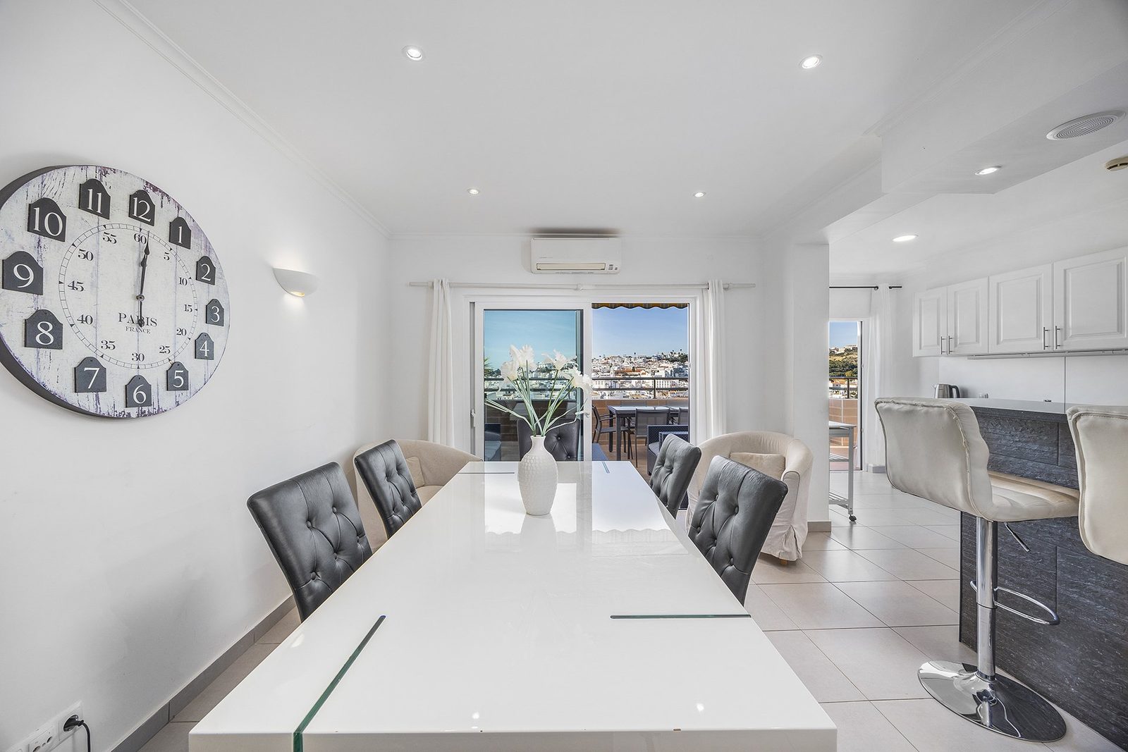 Dining area with views to two balconies and kitchen bar