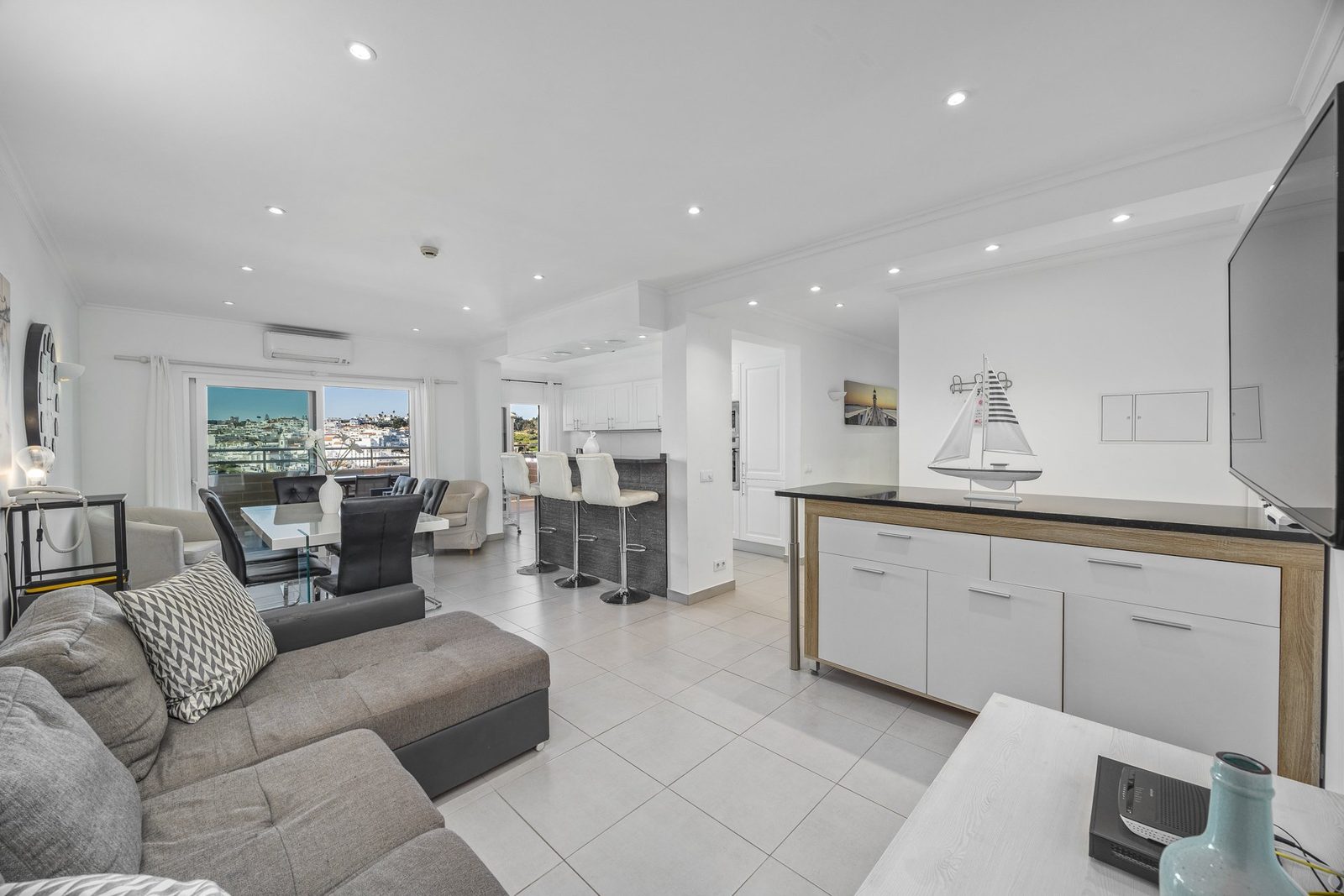 Open-plan living area with dining table and kitchen, alternate view