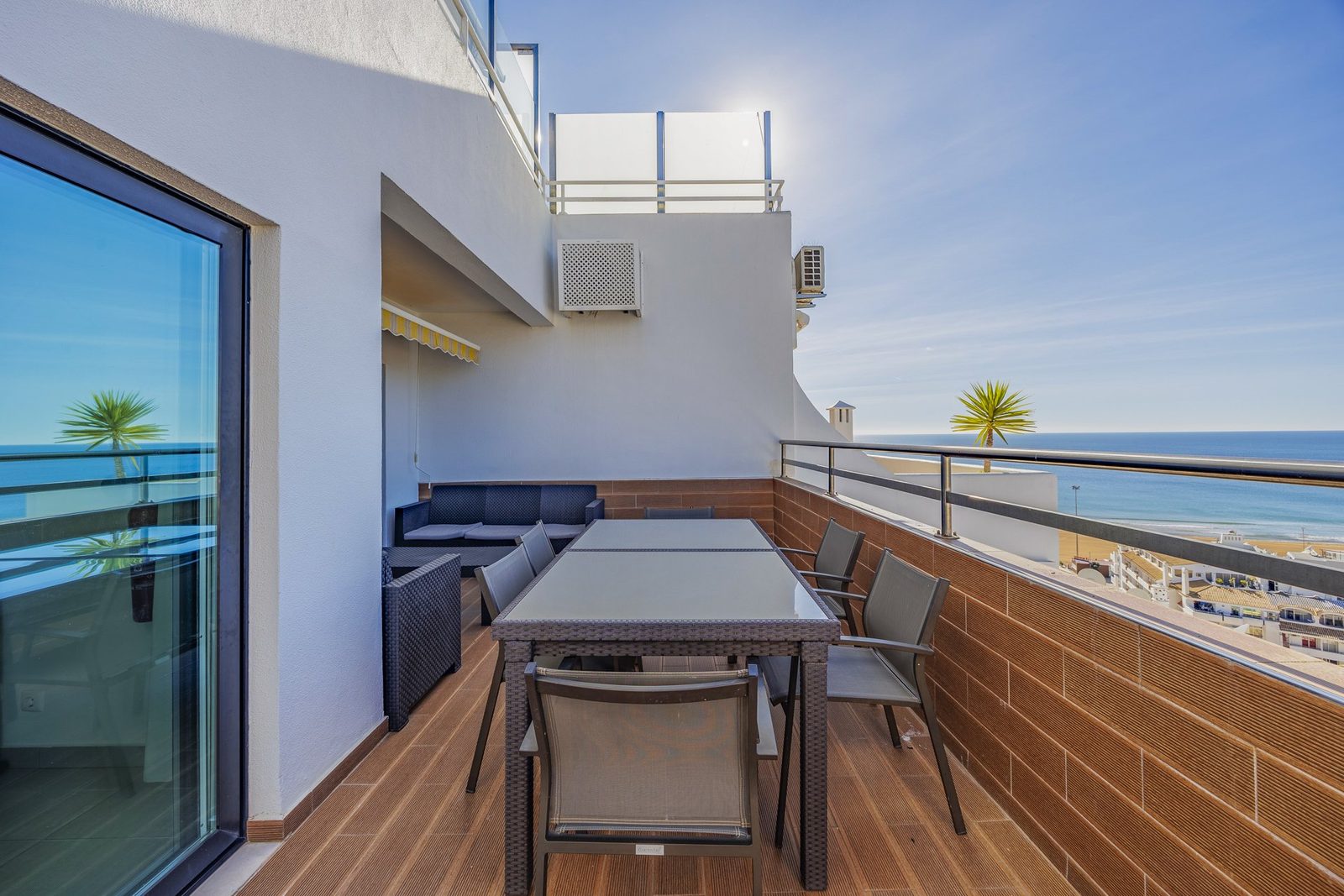 Terrace with dining table and sea view