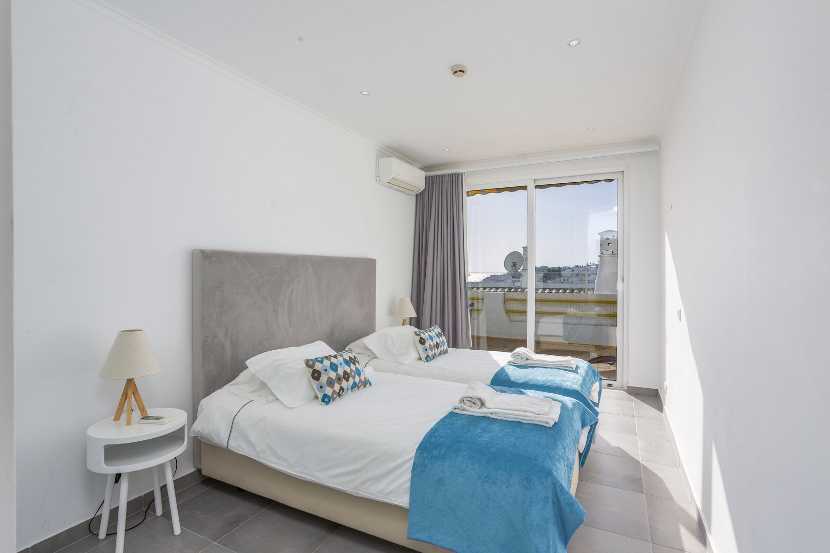 Bedroom with balcony access and rooftop view
