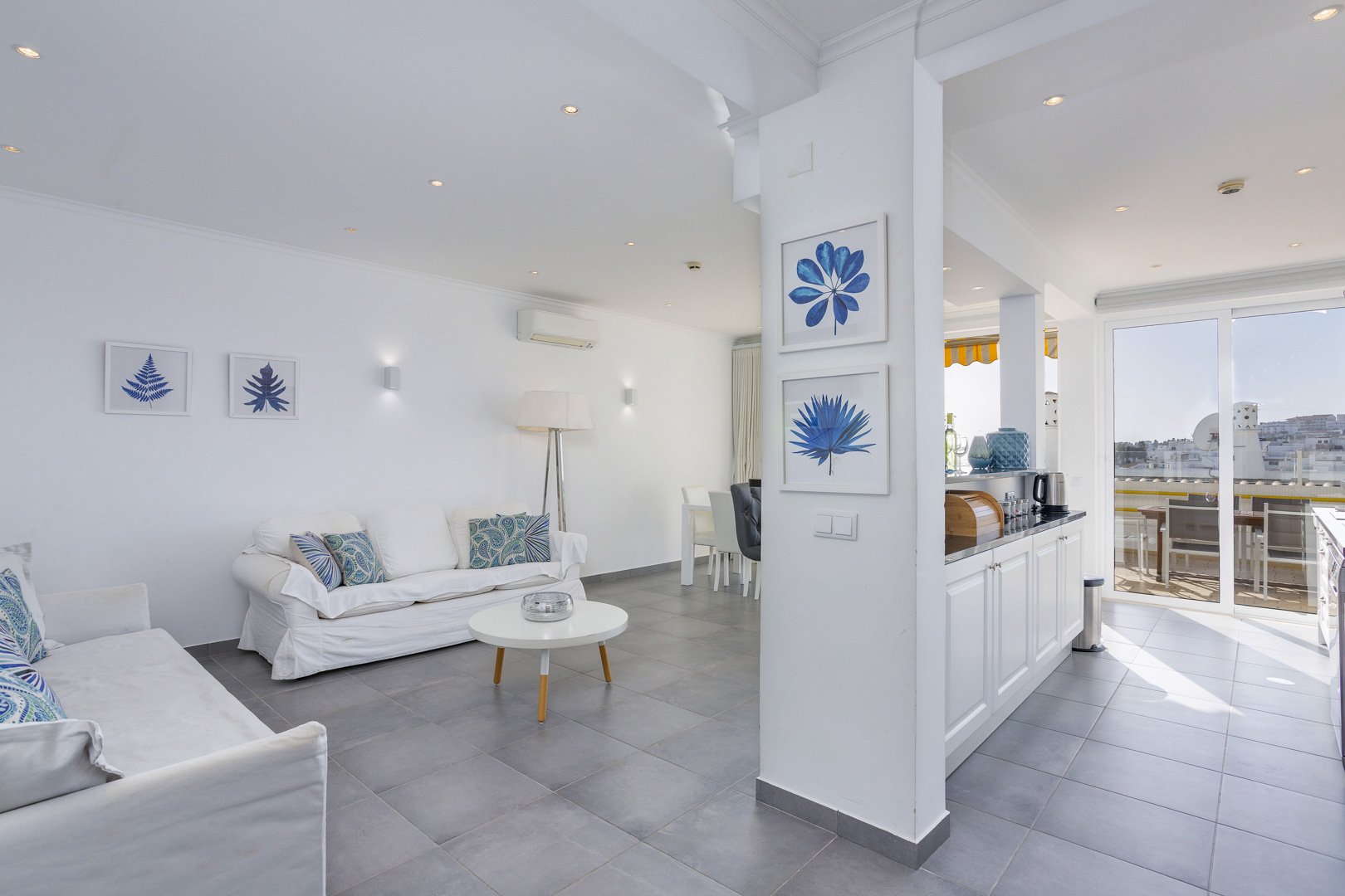 Living room with kitchen and balcony access