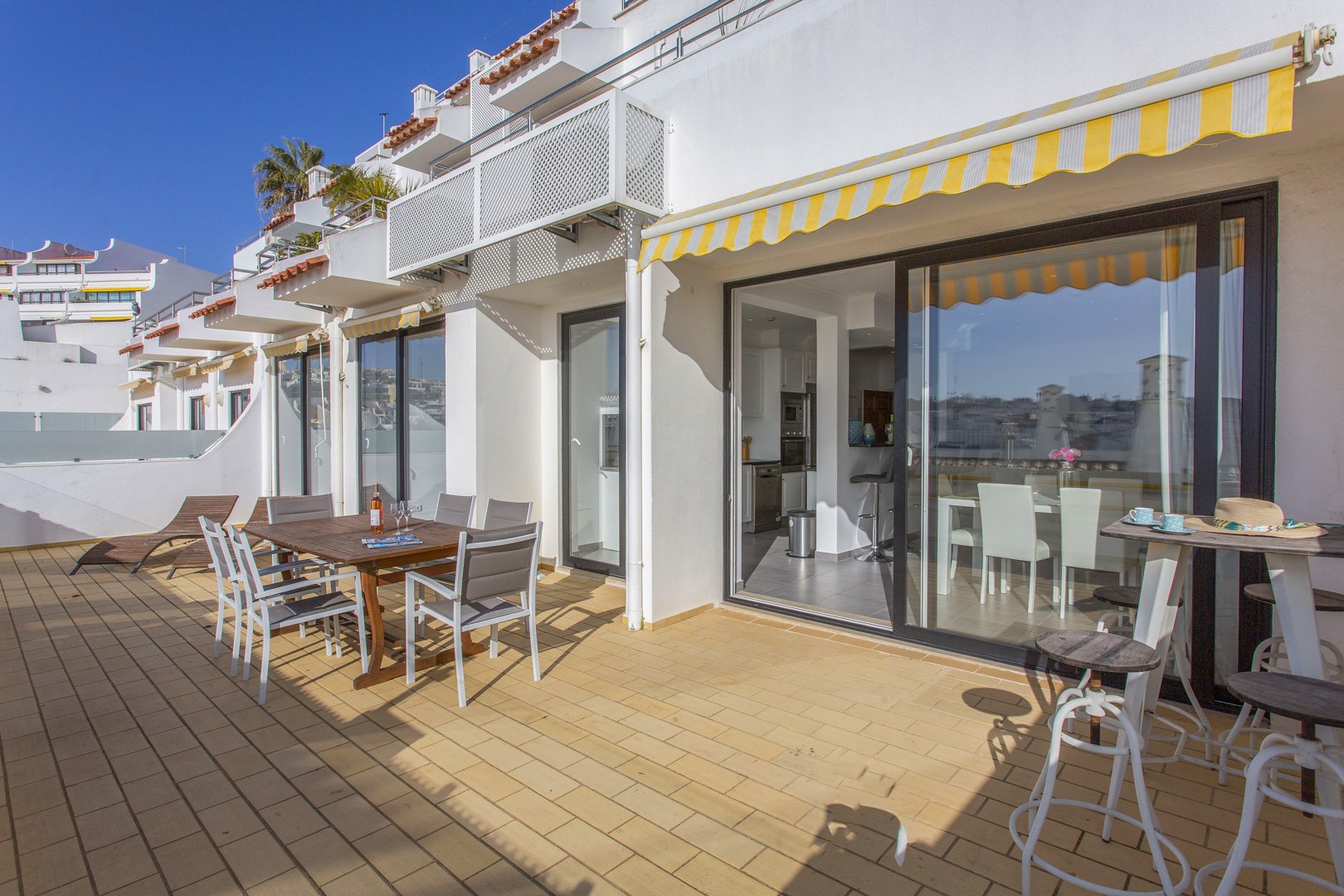 Terrace along the building with dining table