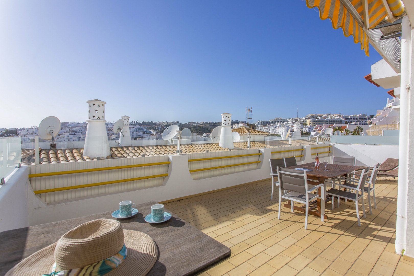 Terrace with dining table and rooftop view