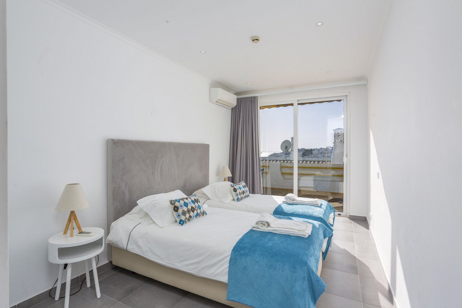 Bedroom with balcony access and rooftop view