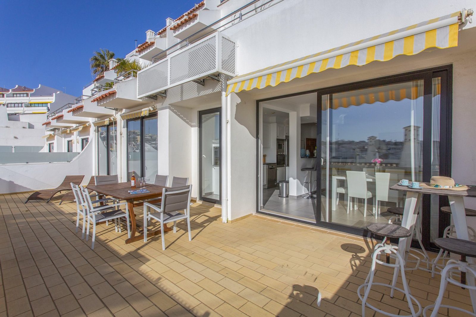 Terrace along the building with dining table