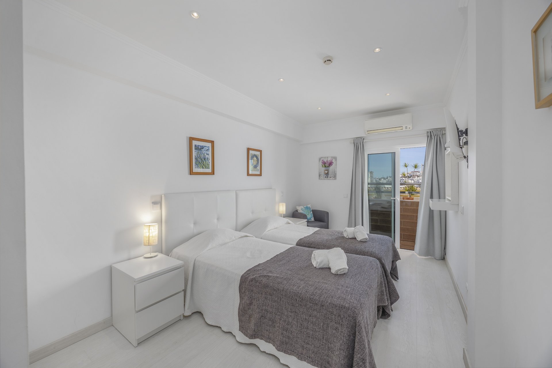 Bedroom with balcony access and town view