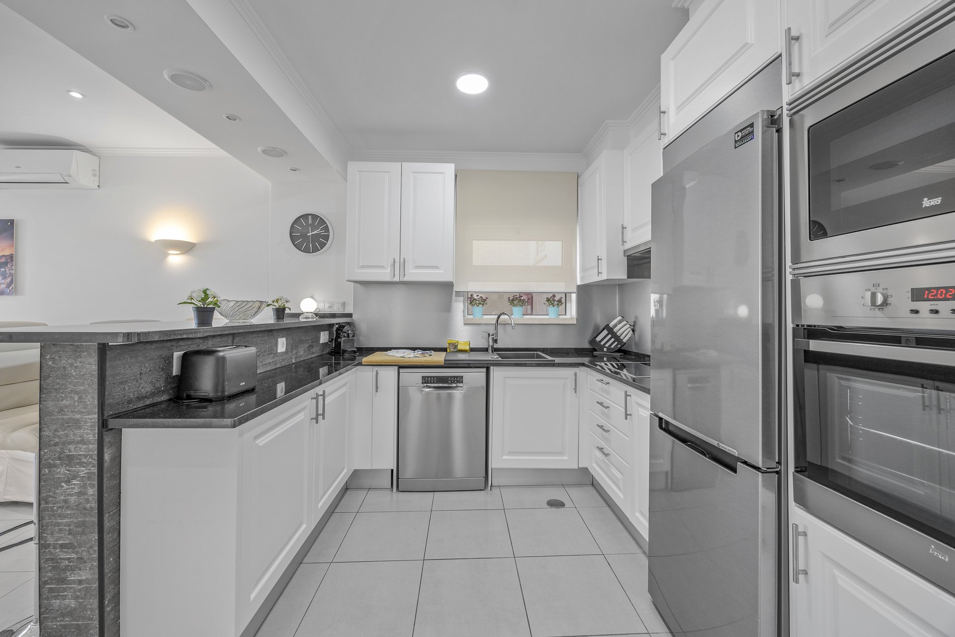 Kitchen with fridge, oven, and microwave