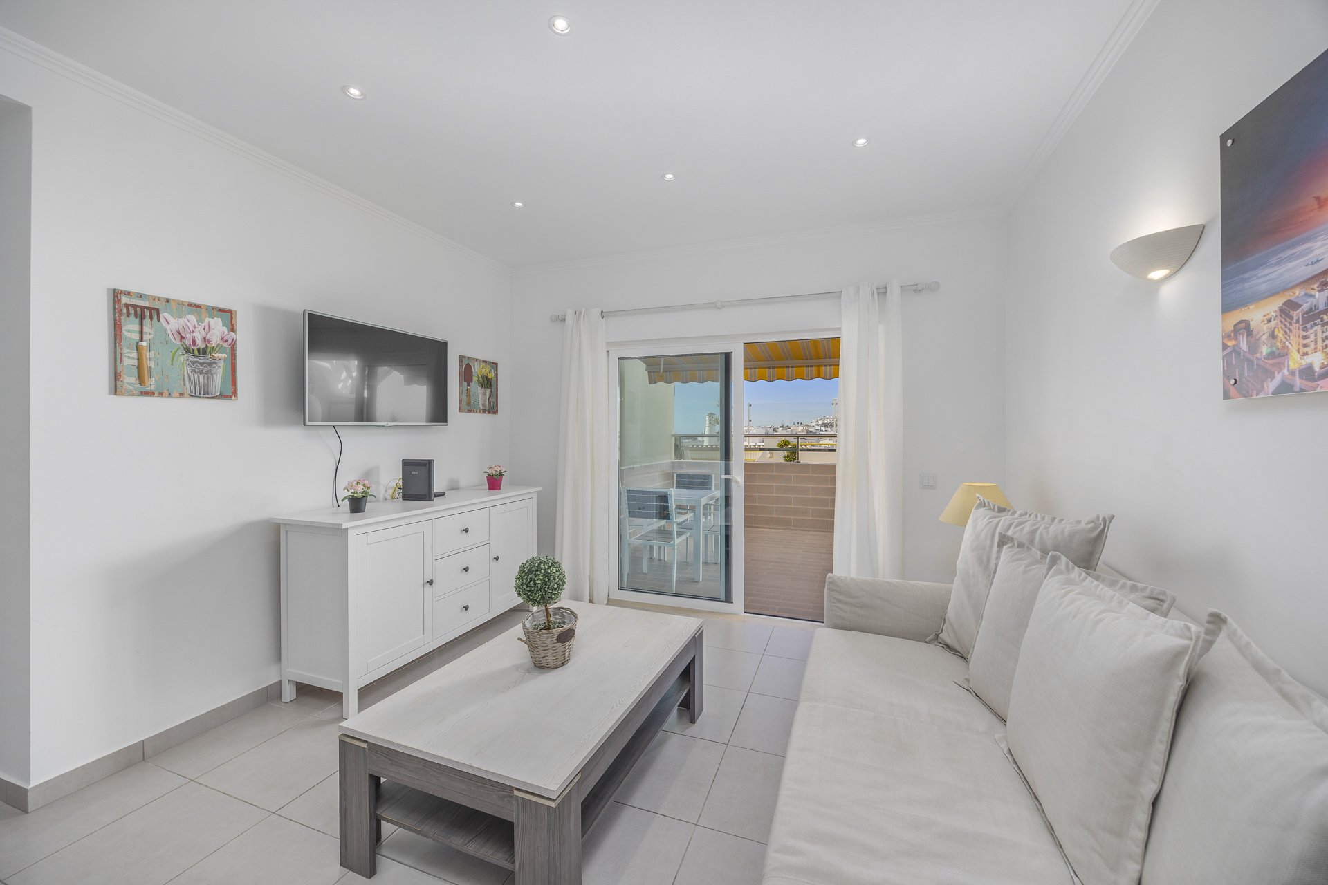 Living room with armchair and balcony access, alternate view