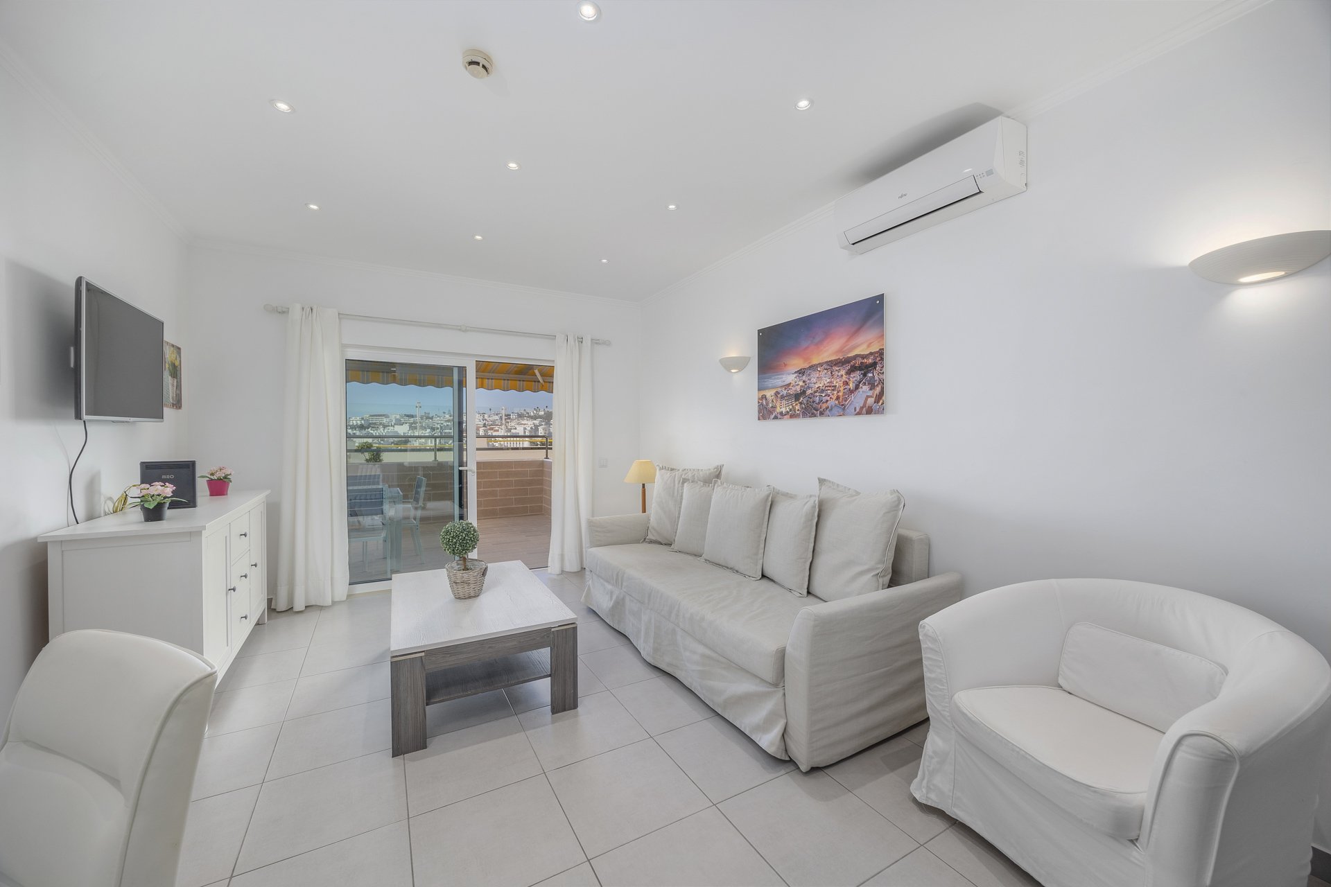Living room with armchair and balcony access