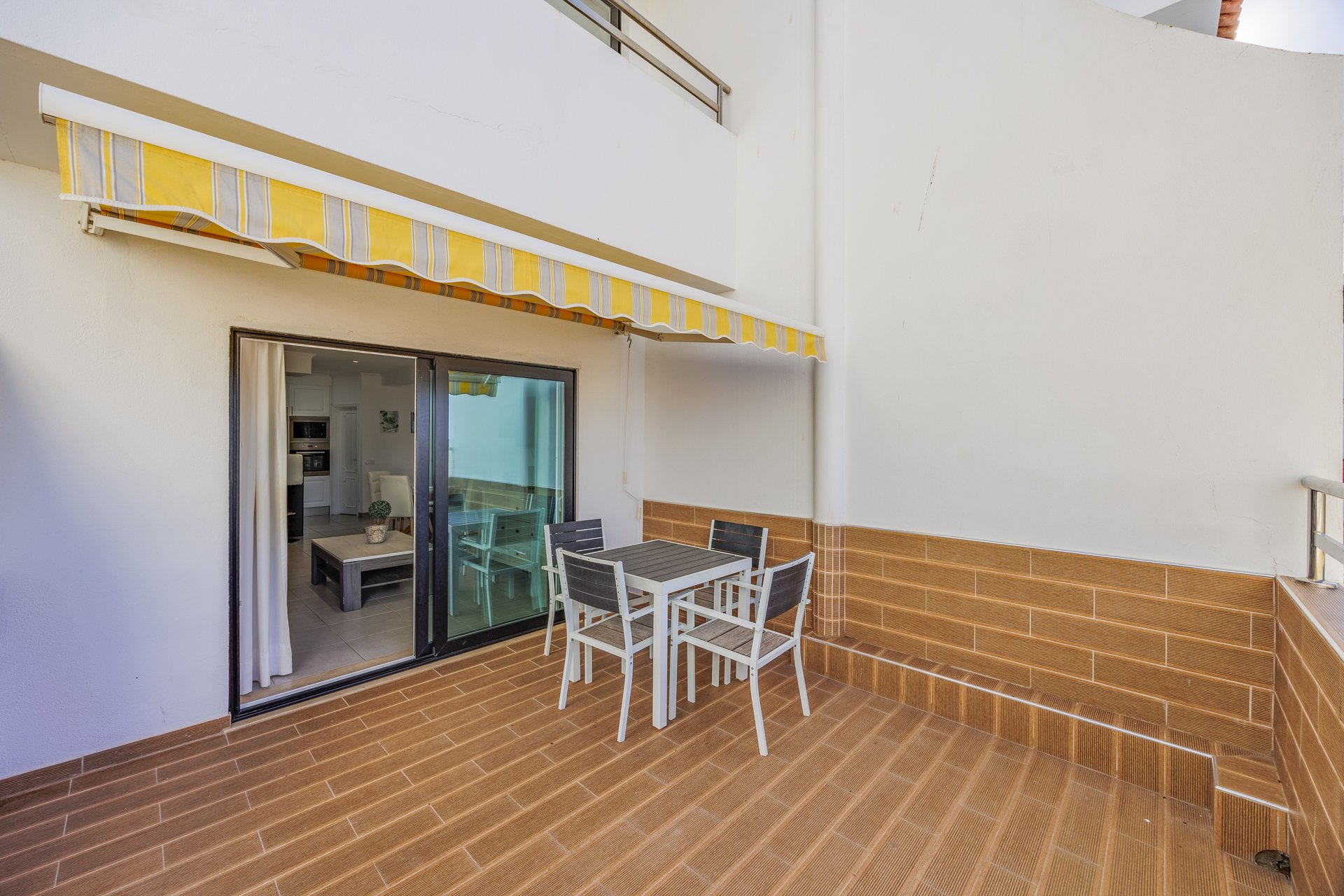 Terrace with dining table and view into the living room