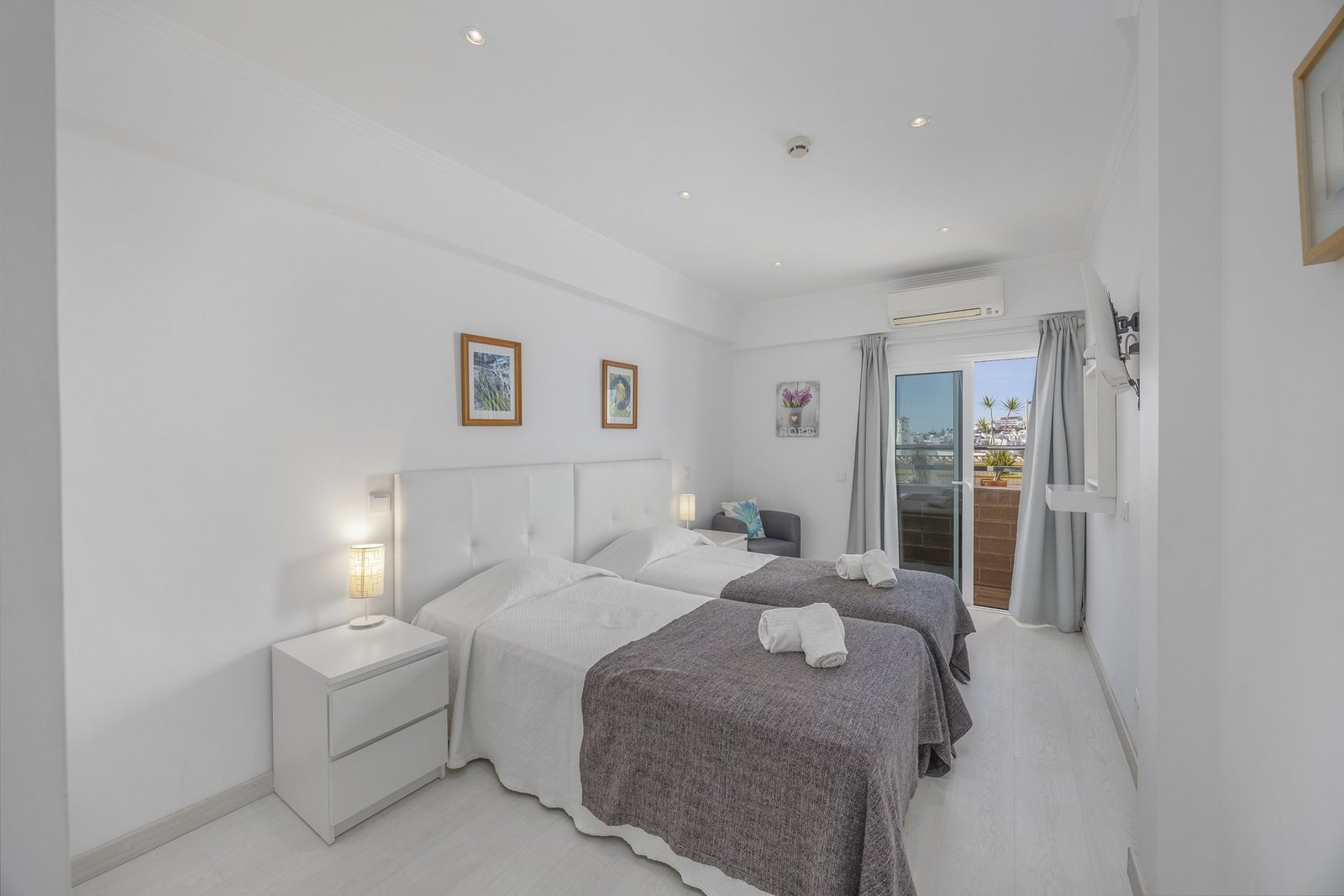 Bedroom with balcony access and town view
