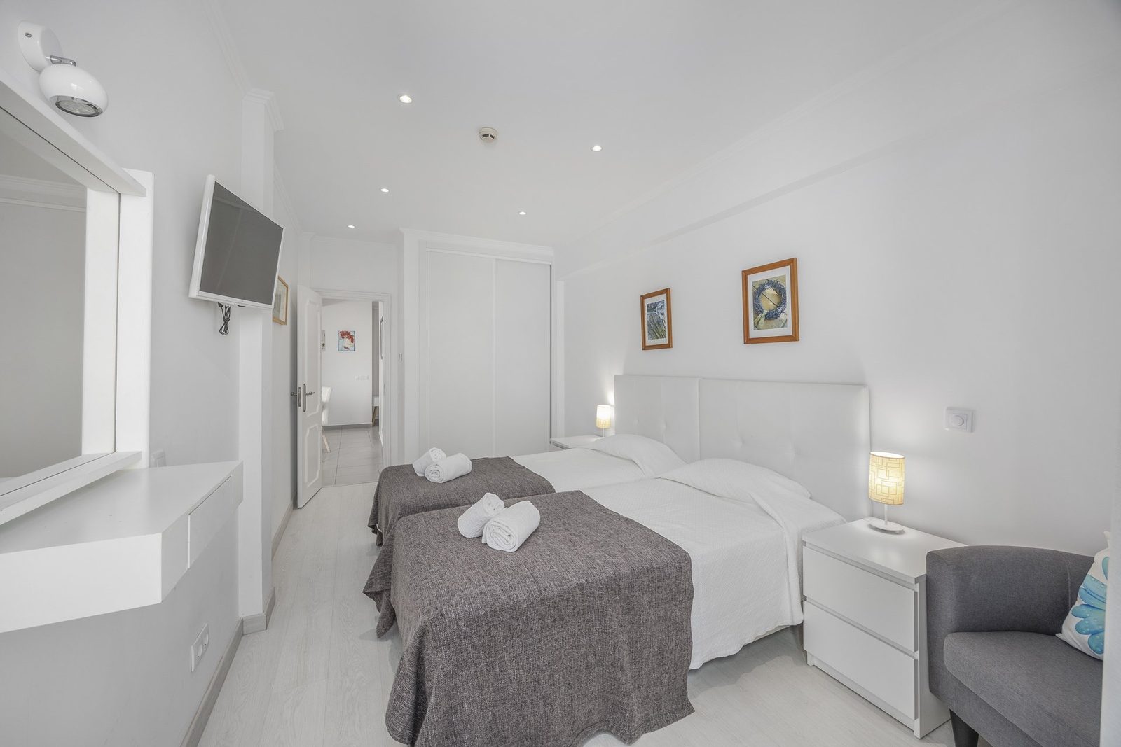 Bedroom with balcony access and town view, alternate view