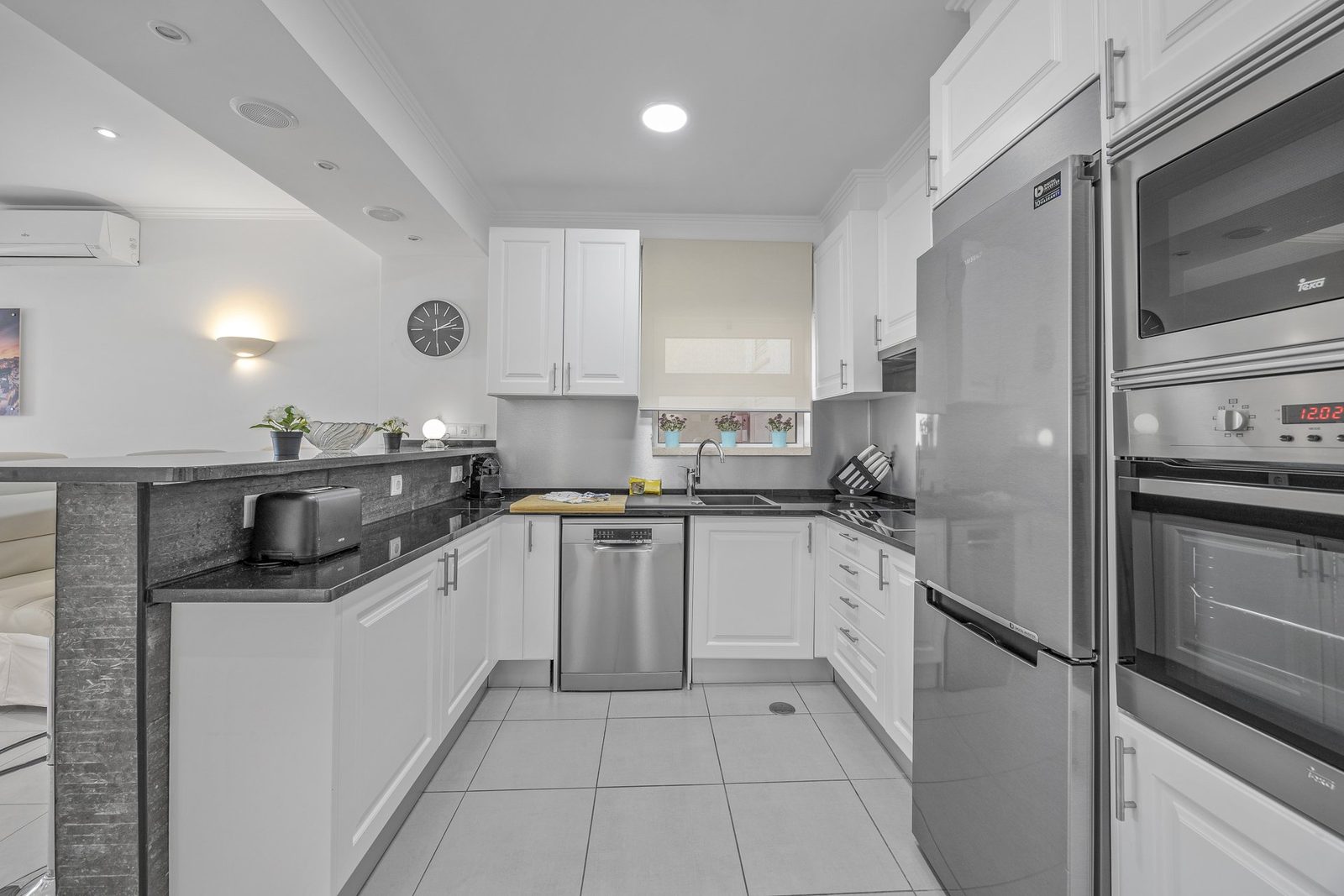 Kitchen with fridge, oven, and microwave