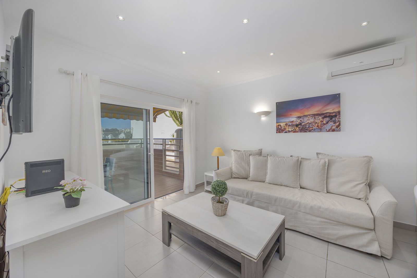 Living room with TV and balcony access, alternate view