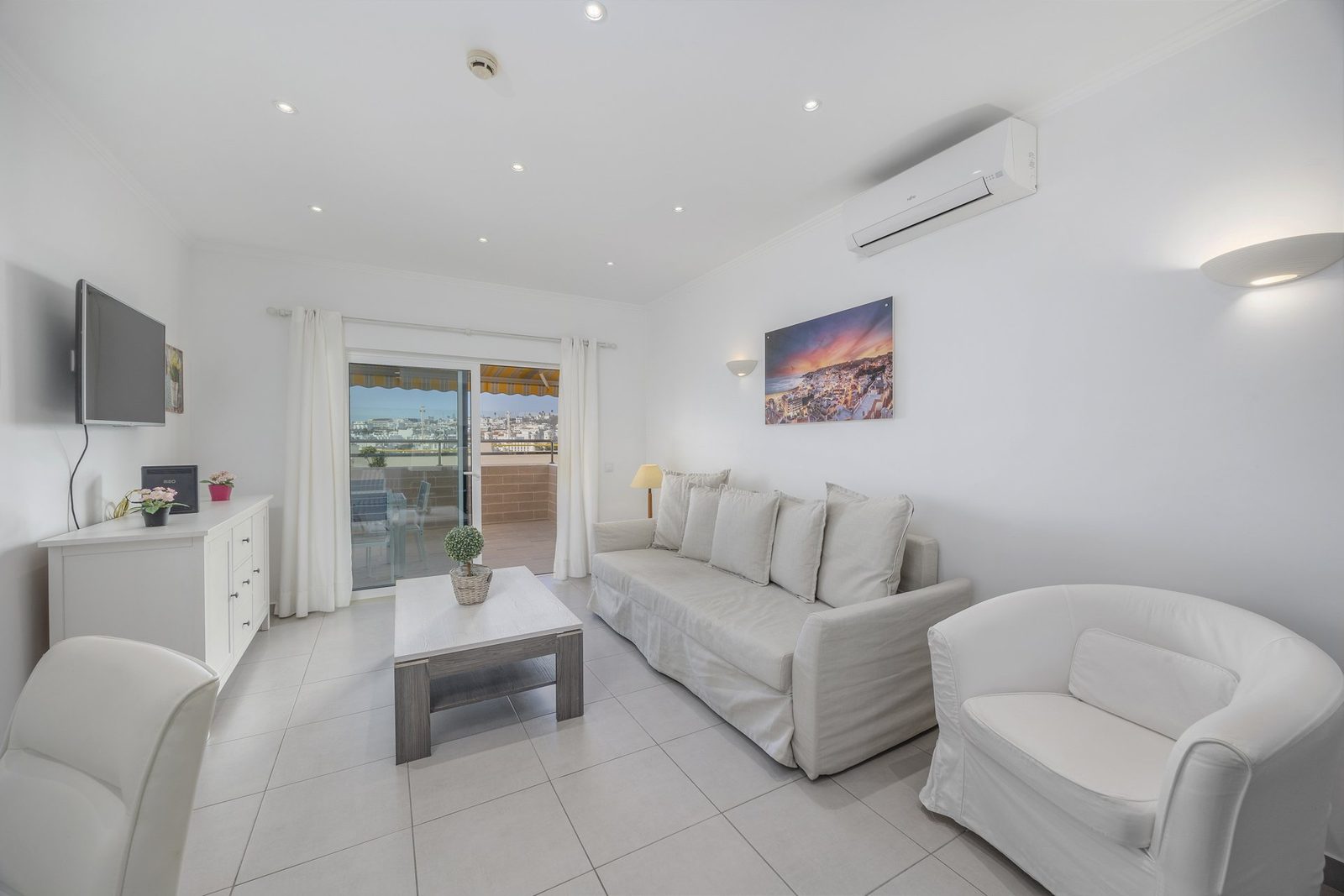 Living room with armchair and balcony access