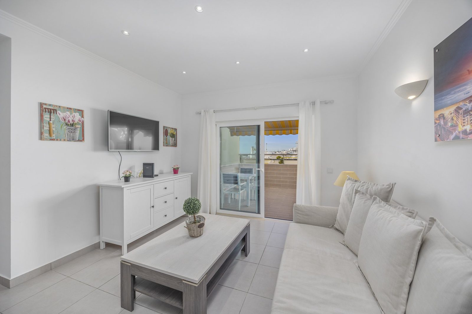 Living room with armchair and balcony access, alternate view