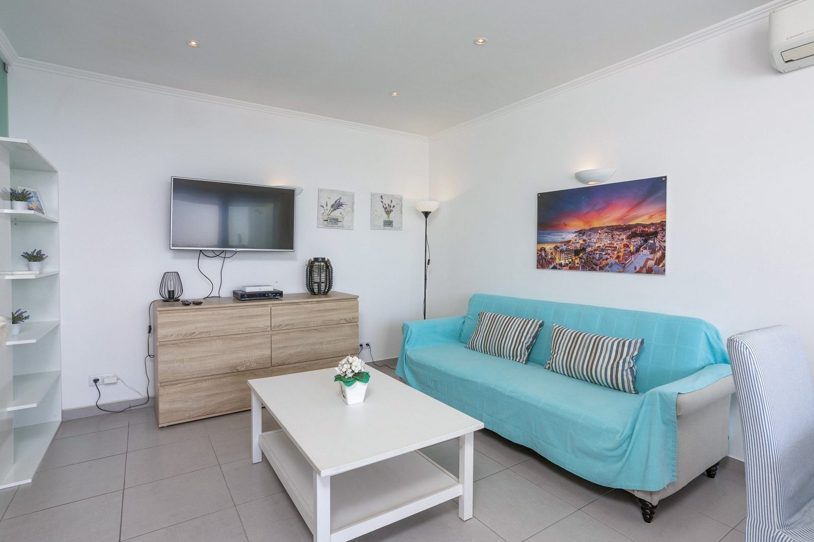 Living room with TV and sunset artwork