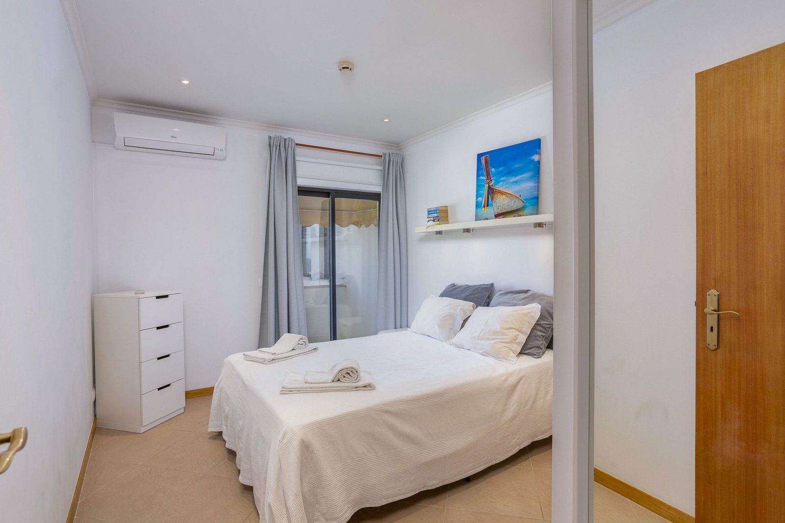 Bedroom with balcony access and decorative artwork